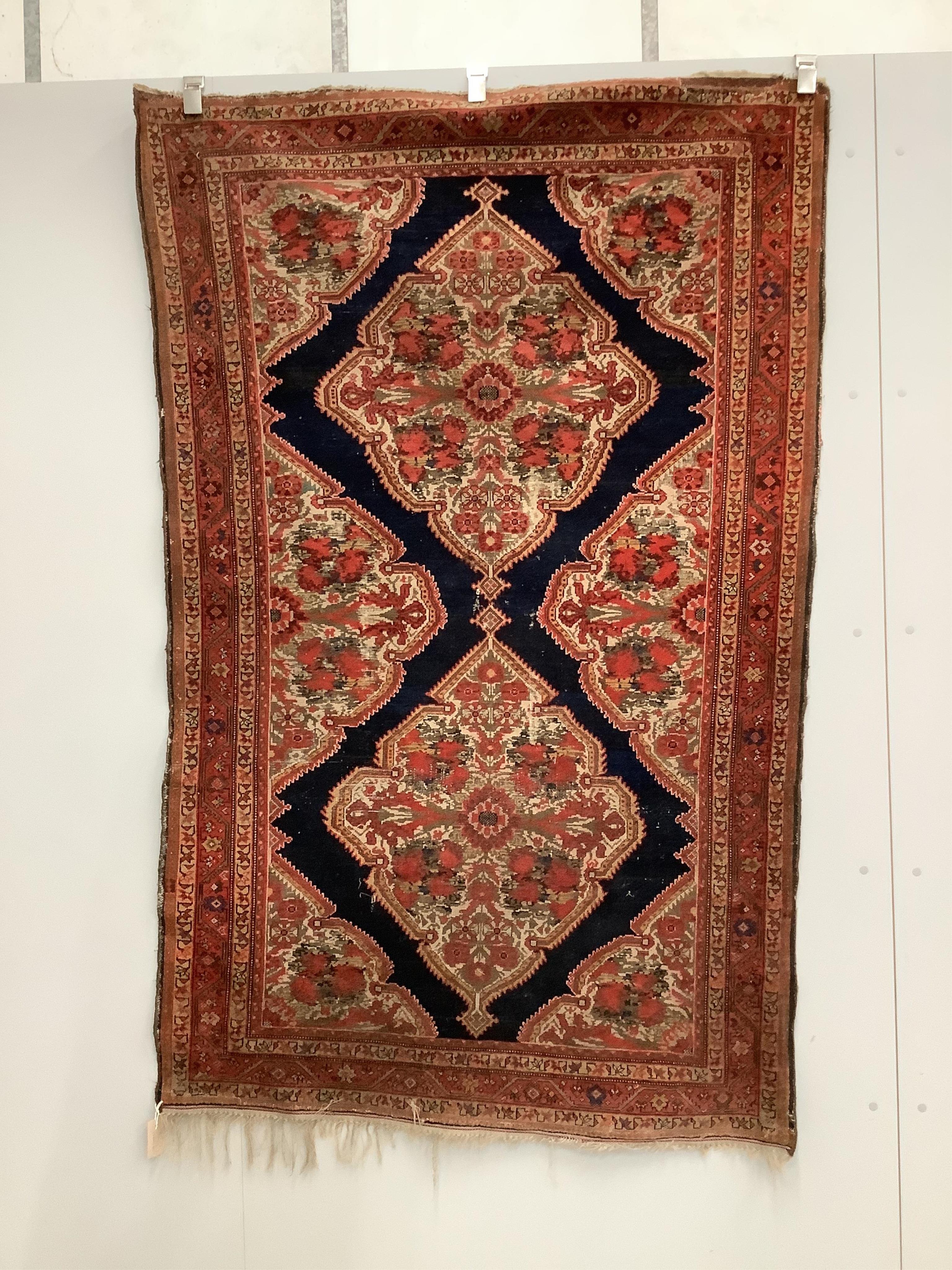 A North West Persian red ground rug, 186 x 120cm. Condition - faded with some wear                                                                                                                                          