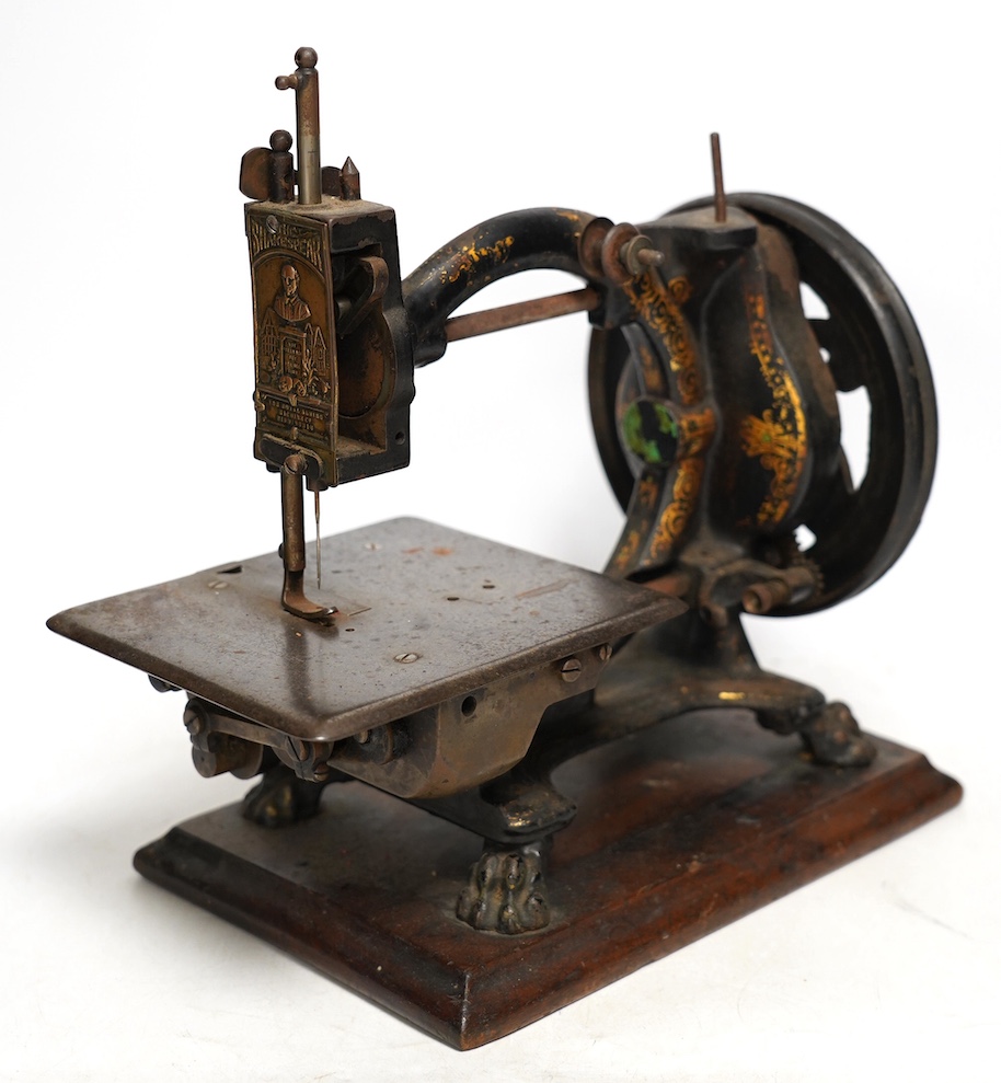 A late 19th century The Royal Sewing machine Co Shakespeare sewing machine, on a mahogany base with gilt decoration to the frame. Condition - fair                                                                          