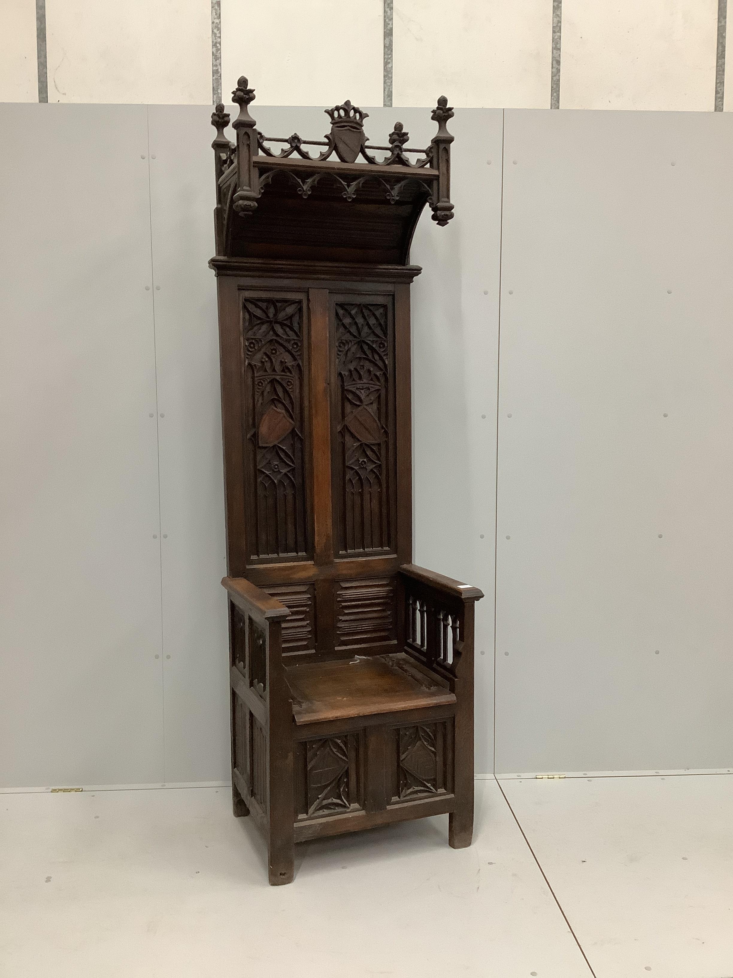 A Gothic style carved oak throne chair with hinged box seat, width 69cm, depth 53cm, height 230cm                                                                                                                           