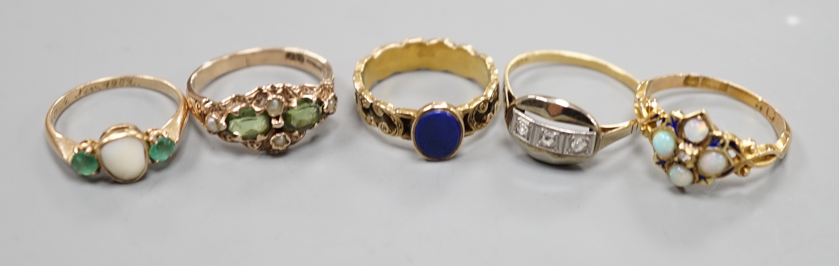 Five assorted early 20th century and later gem set rings, including 15ct white opal and enamel size O, gross weight 2.6 grams, a 585 emerald and white stone ring, gross 2 grams and three others including 9ct gold, gross 