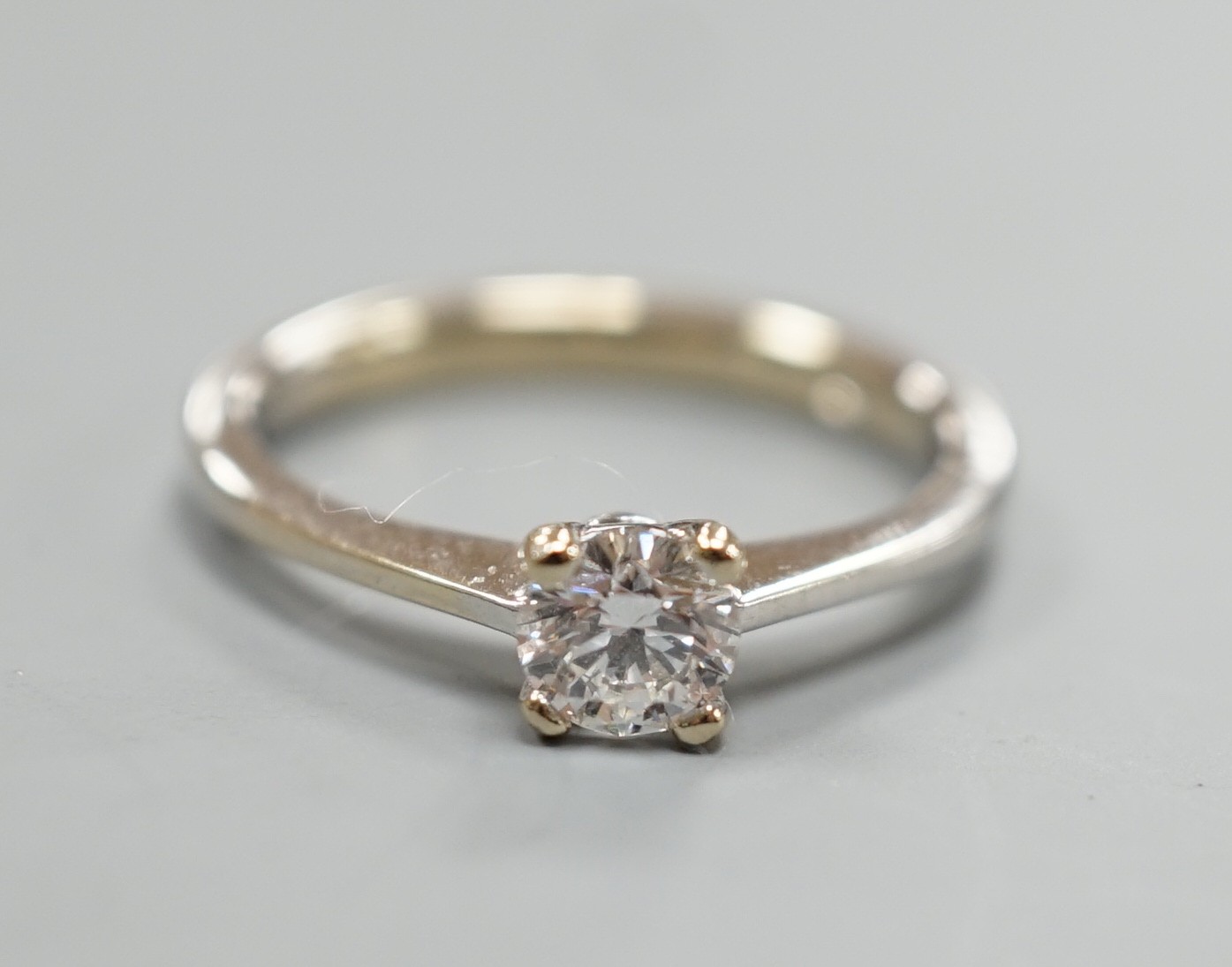 A modern Italian 750 white metal and solitaire diamond ring, size L/M, gross weight 2.8 grams.                                                                                                                              