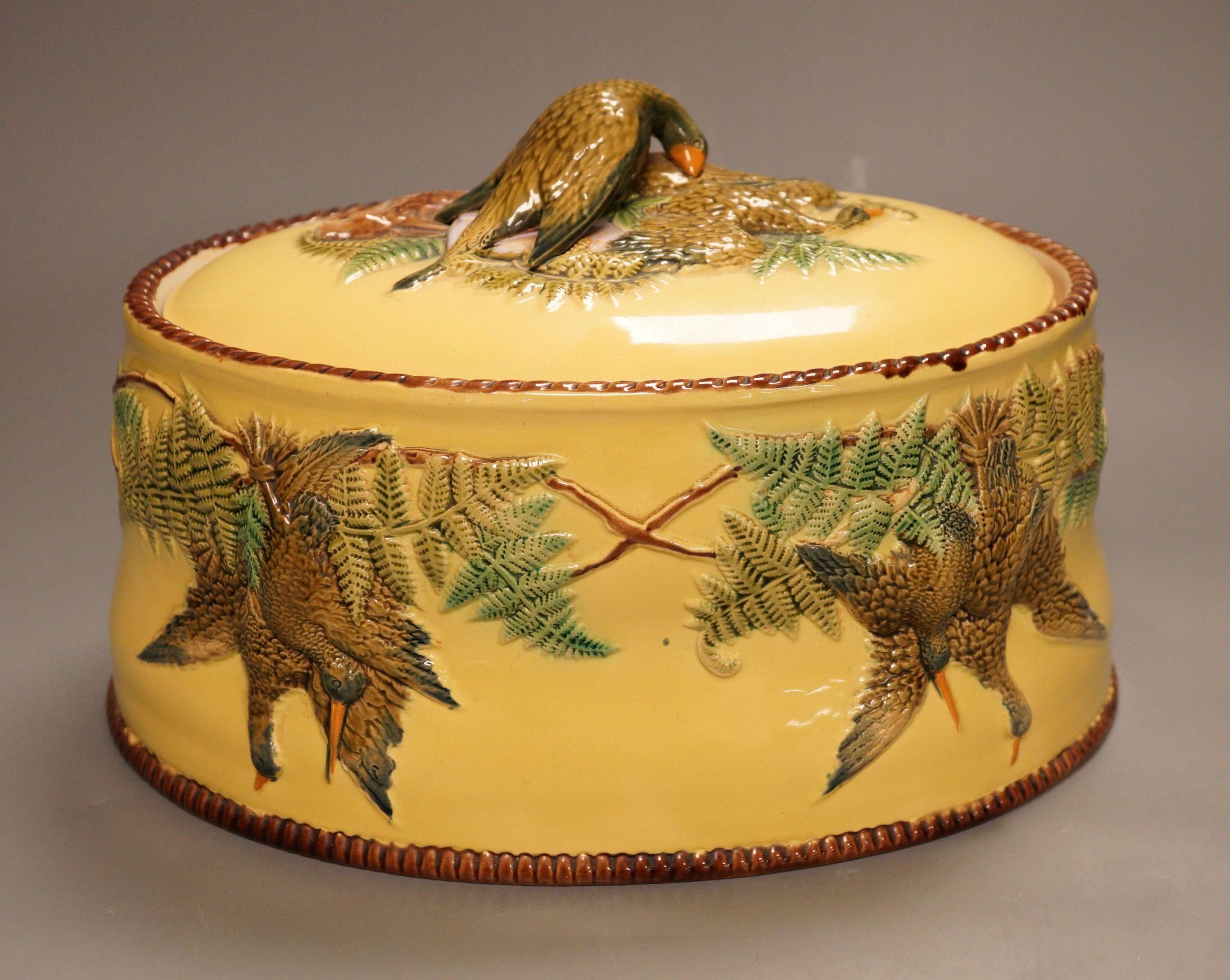 A Continental majolica game tureen with floral and bird relief, 18cm tall                                                                                                                                                   