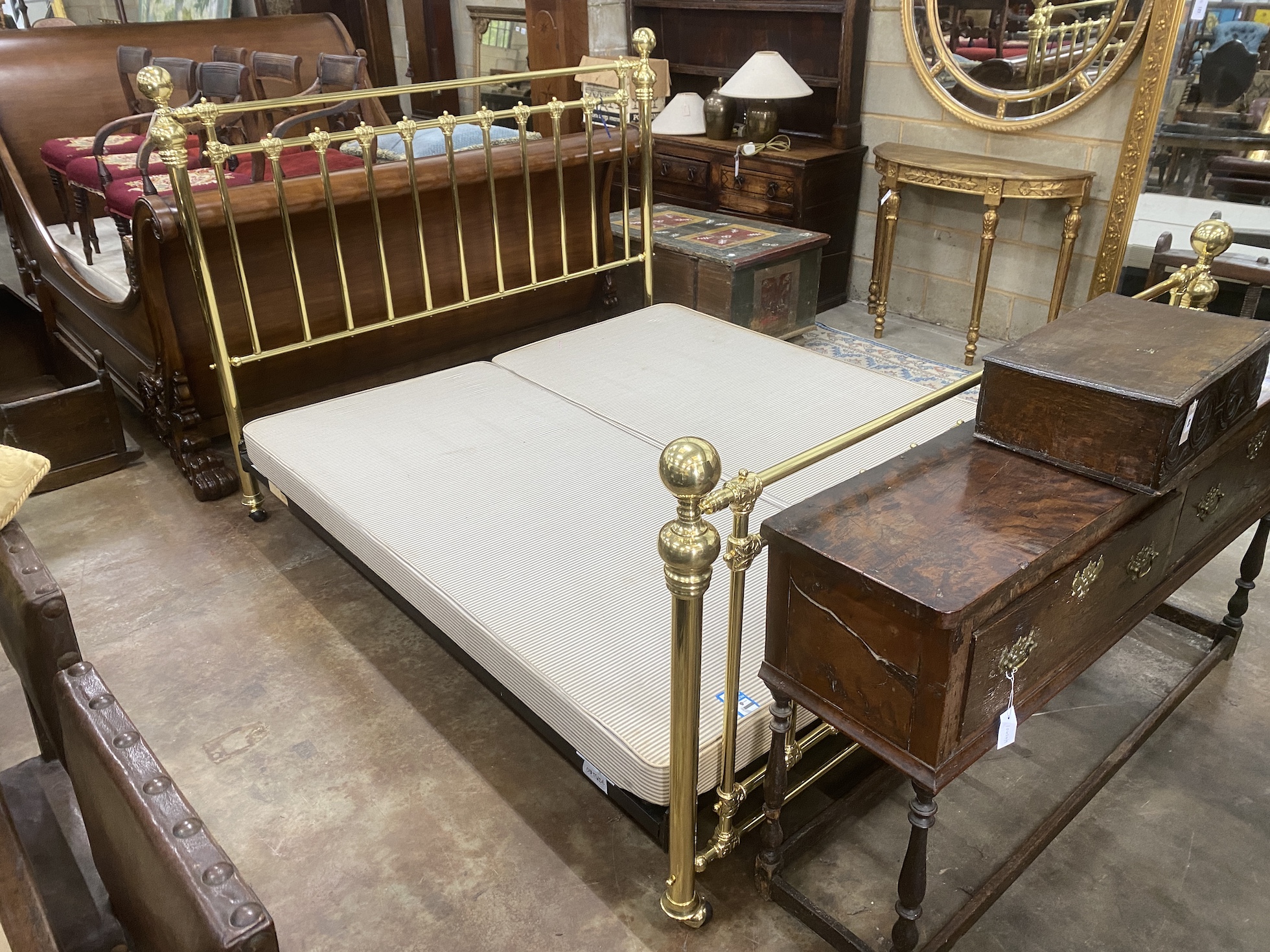 A Victorian style super kingsize tubular brass bedstead, with box base, length approx. 220cm, width 188cm, height 141cm                                                                                                     