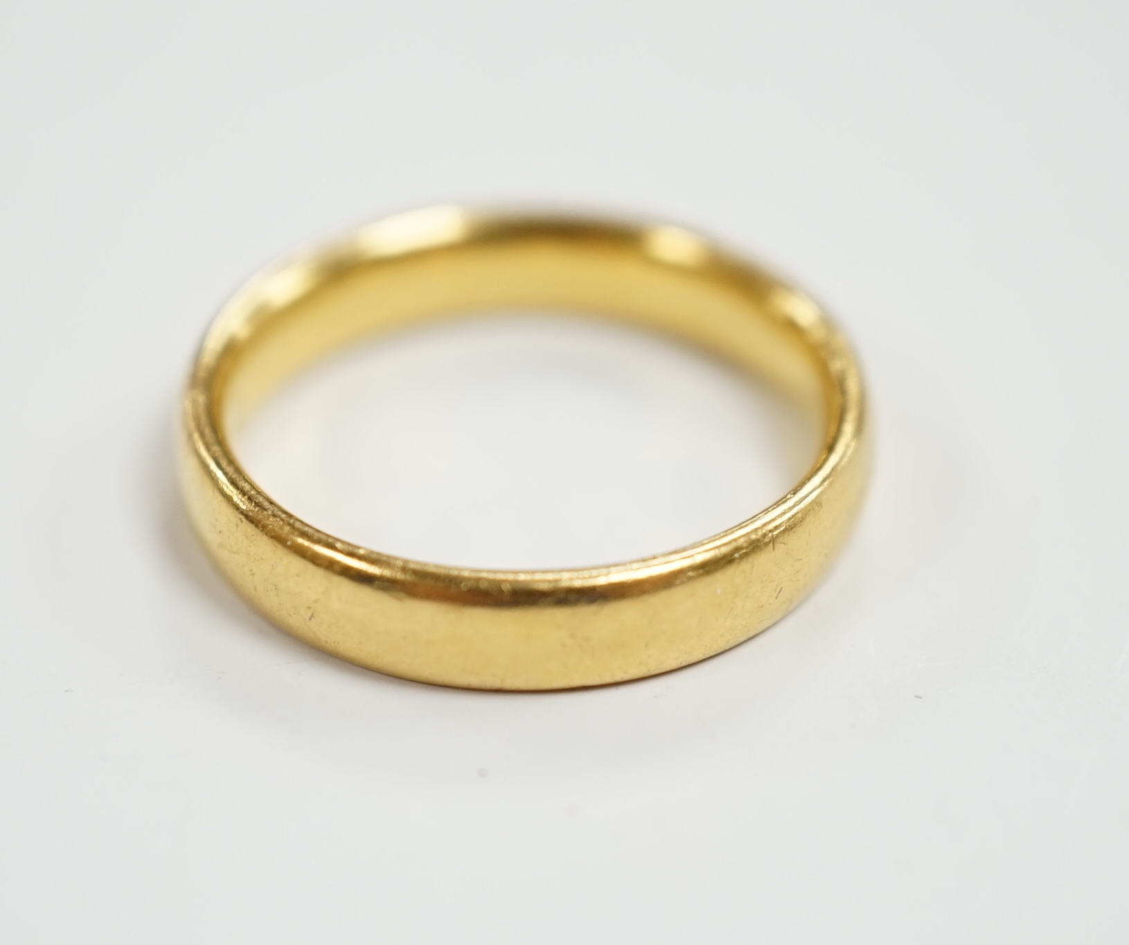 A George V 22ct gold wedding band, size H, 4.3 grams.                                                                                                                                                                       