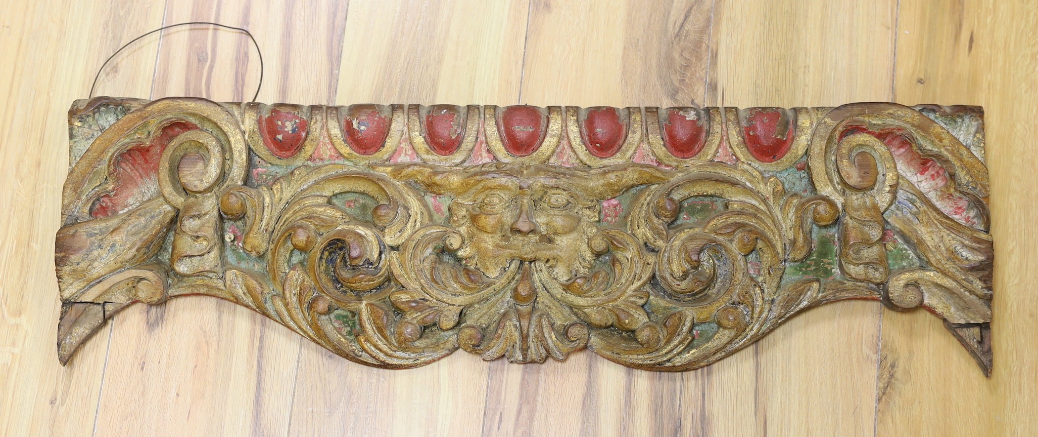 A carved wood 'fairground' panel, 76 cms wide                                                                                                                                                                               