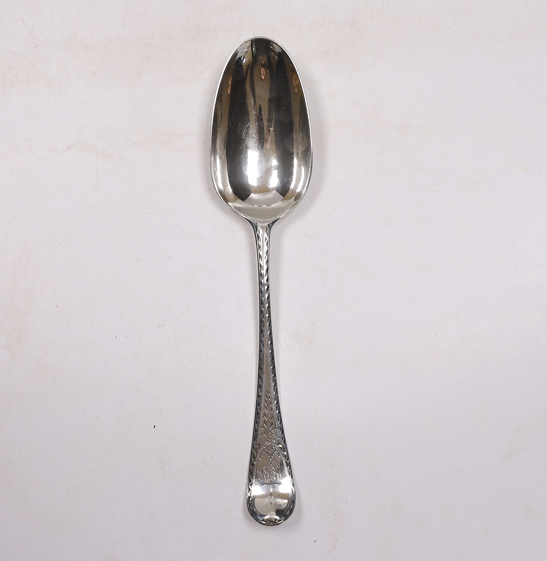 A late George II? bright cut engraved base mark table spoon, marks pinched and rubbed, 20.3cm, 64 grams.                                                                                                                    