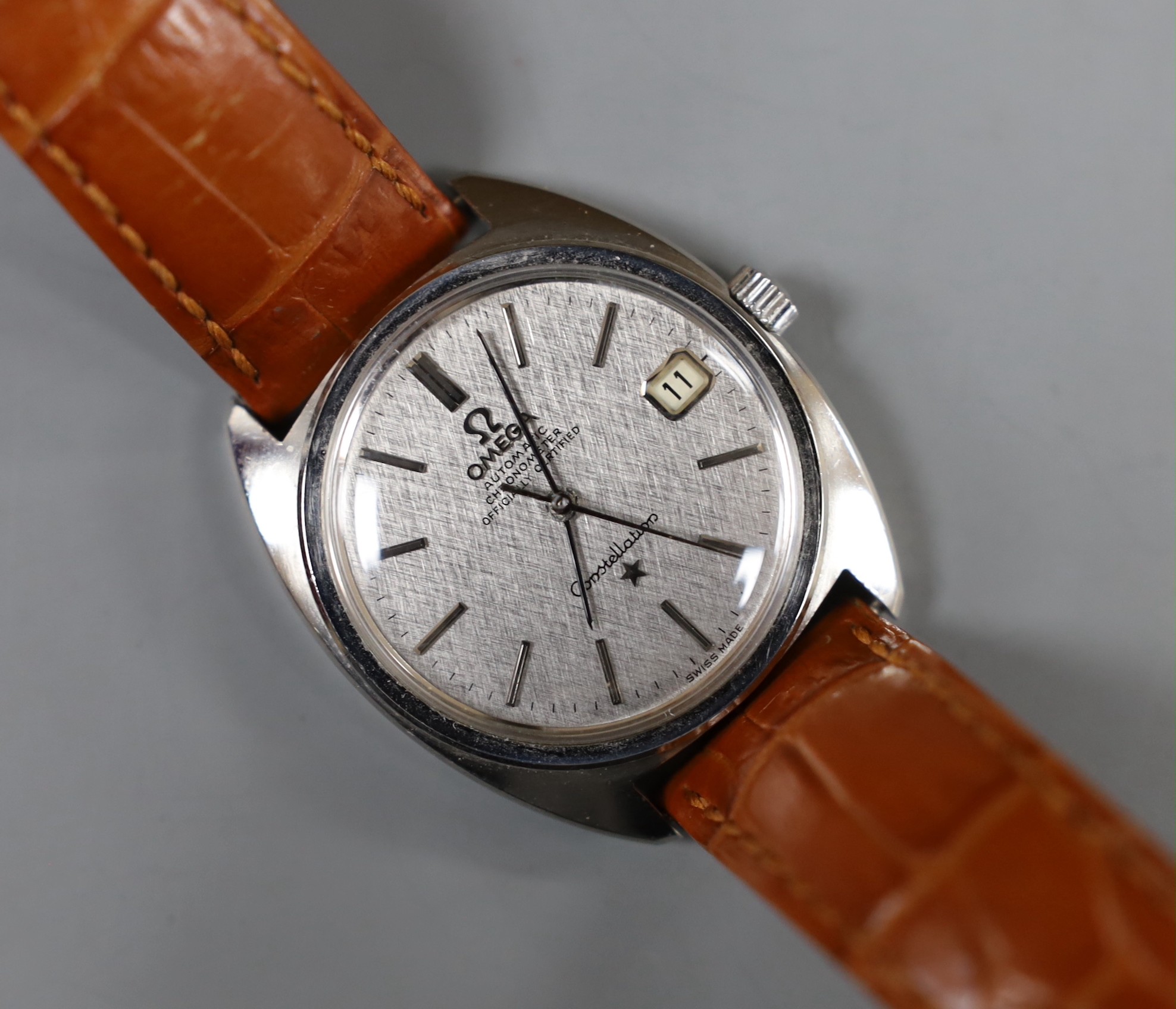 A gentleman's stainless steel Omega Constellation automatic wrist watch, with original box, on associated leather strap.                                                                                                    