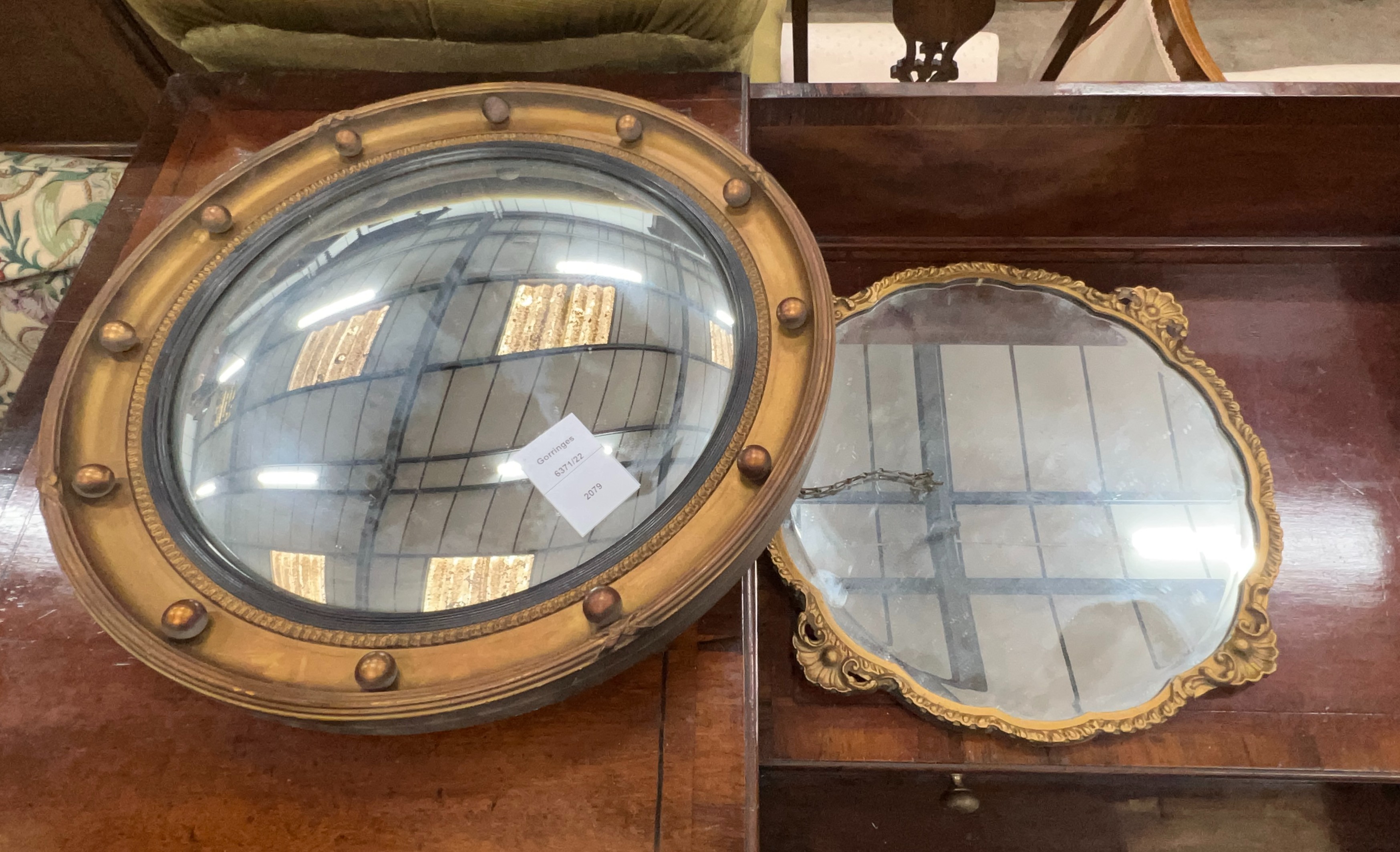 A Regency style circular convex wall mirror, diameter 45cm together with one other circular wall mirror                                                                                                                     