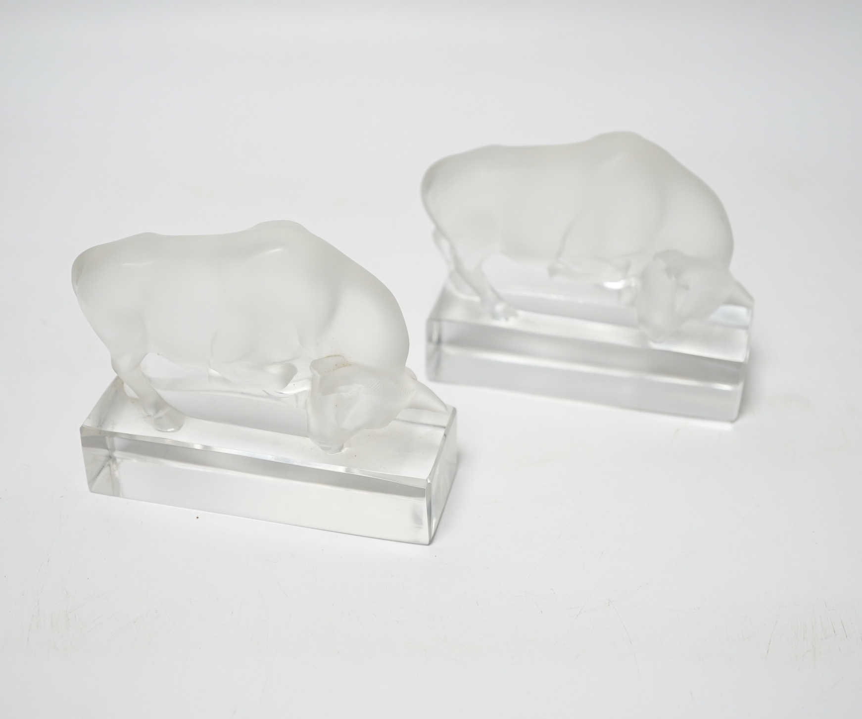 Rene Lalique, two frosted glass paperweights modelled as a bull, signed ‘Lalique France’ to base, 9cm high                                                                                                                  