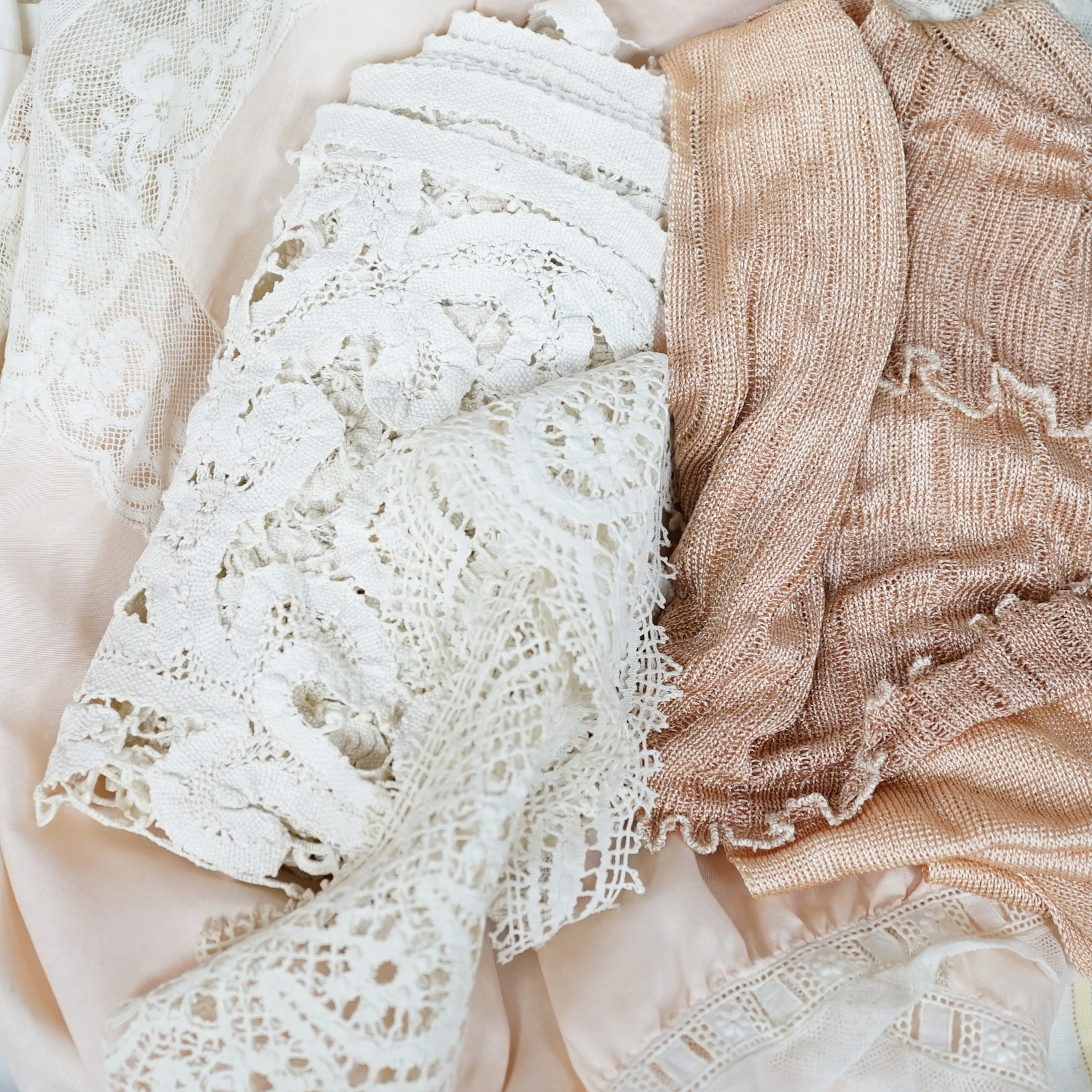 Two Edwardian pink silk and lace inserted camisole tops, a fine 1920’s blouse, a chemise and a pink silk knitted scarf, a bobbin lace collar and length of trimming                                                         