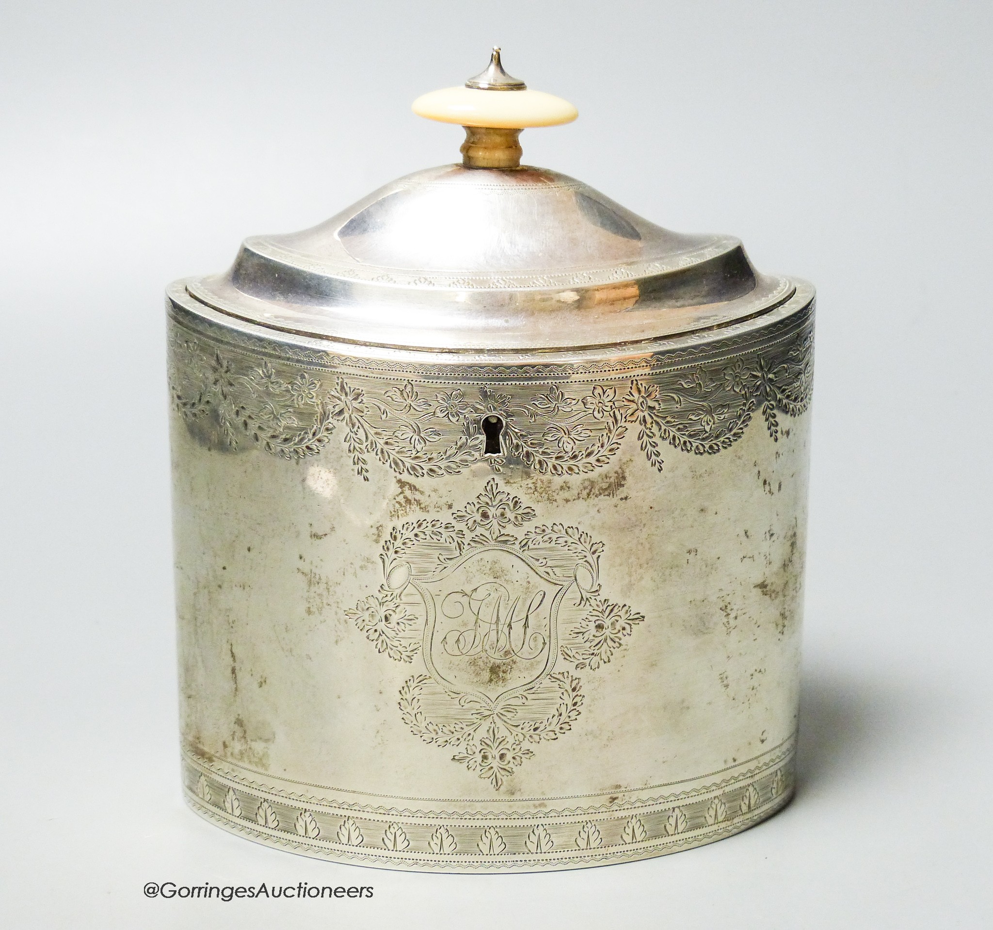 A George III engraved oval tea caddy, with ivory knop, no key, Henry Nutting, London, 1796, length 13.4cm, gross weight 12.5oz.                                                                                             