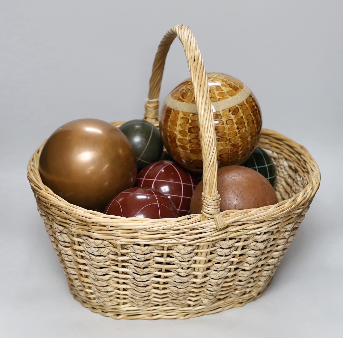 A basket of decorative varying sized balls                                                                                                                                                                                  