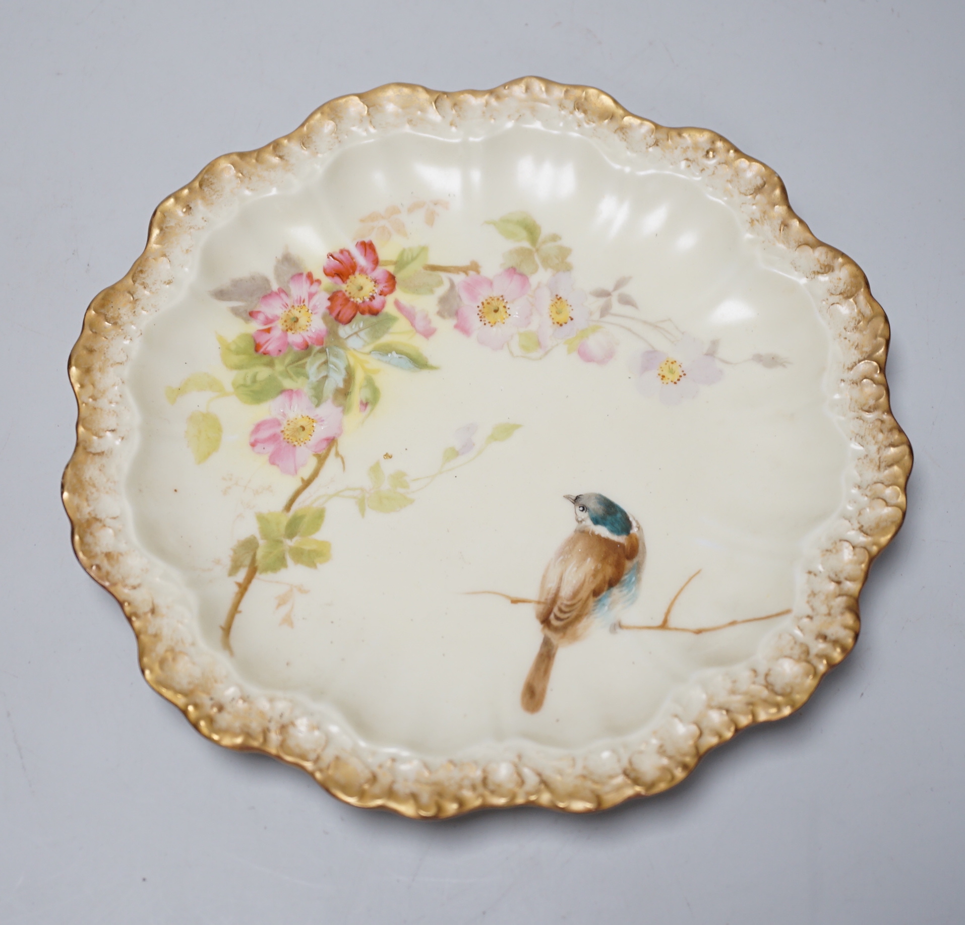 A Limoges dessert service decorated with birds and flowers, the largest 27cm wide                                                                                                                                           