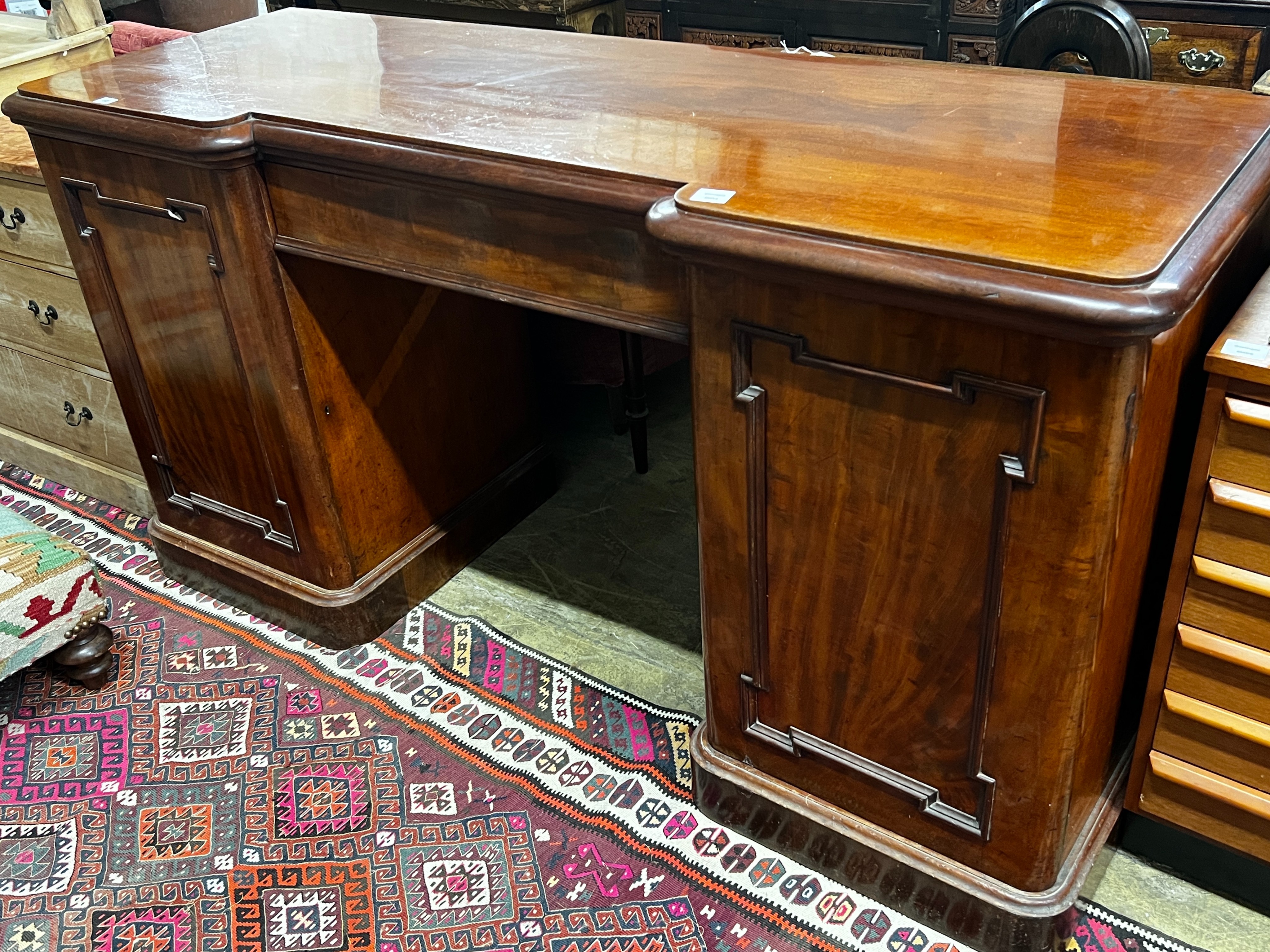 A Victorian mahogany inverse breakfront sideboard, length 180cm, depth 62cm, height 93cm                                                                                                                                    
