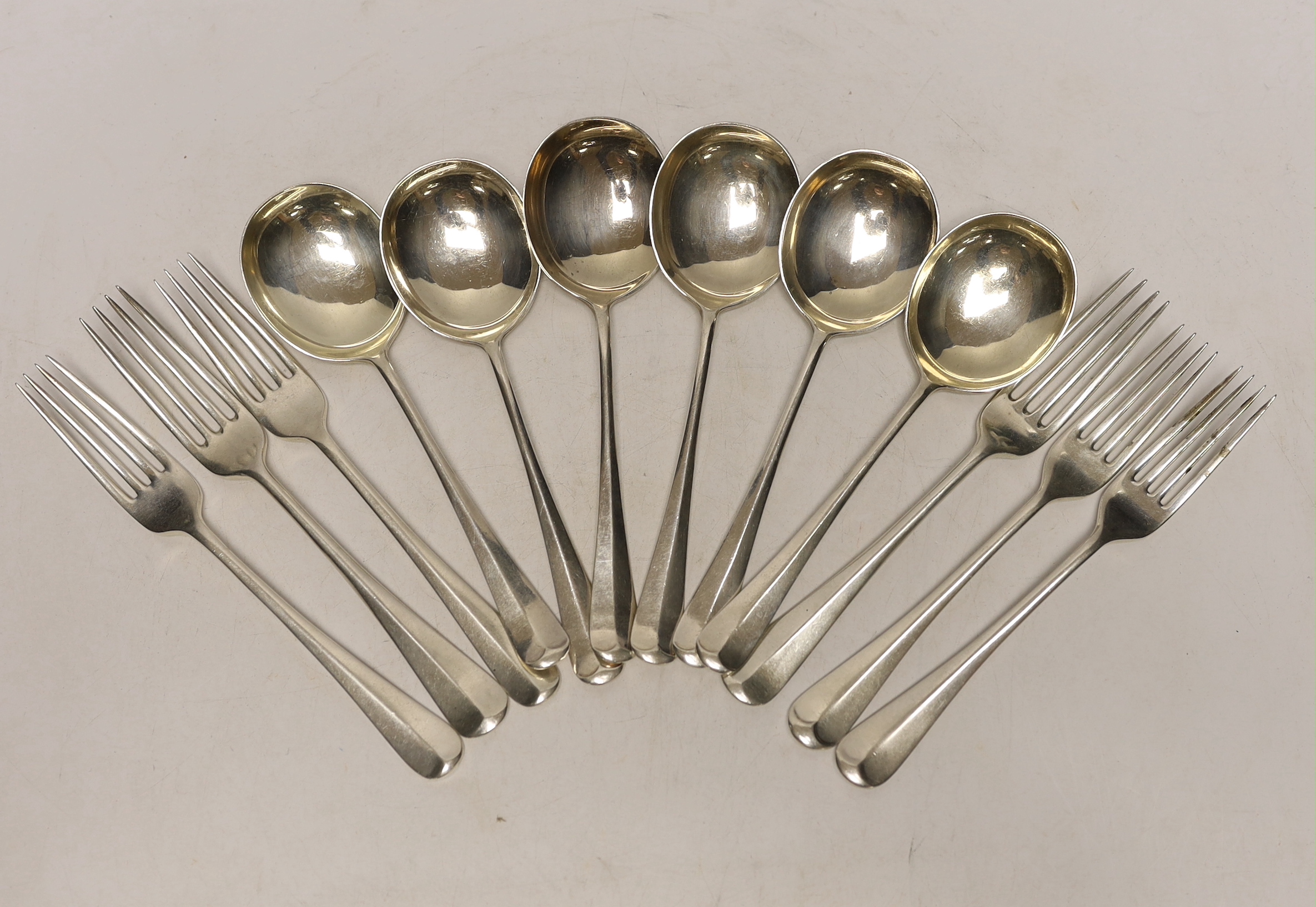 A set of six George VI silver rat tail pattern soup spoons, Cooper Brothers s & Sons, Sheffield, 1937 and six assorted silver dessert forks, 20.3oz.                                                                        