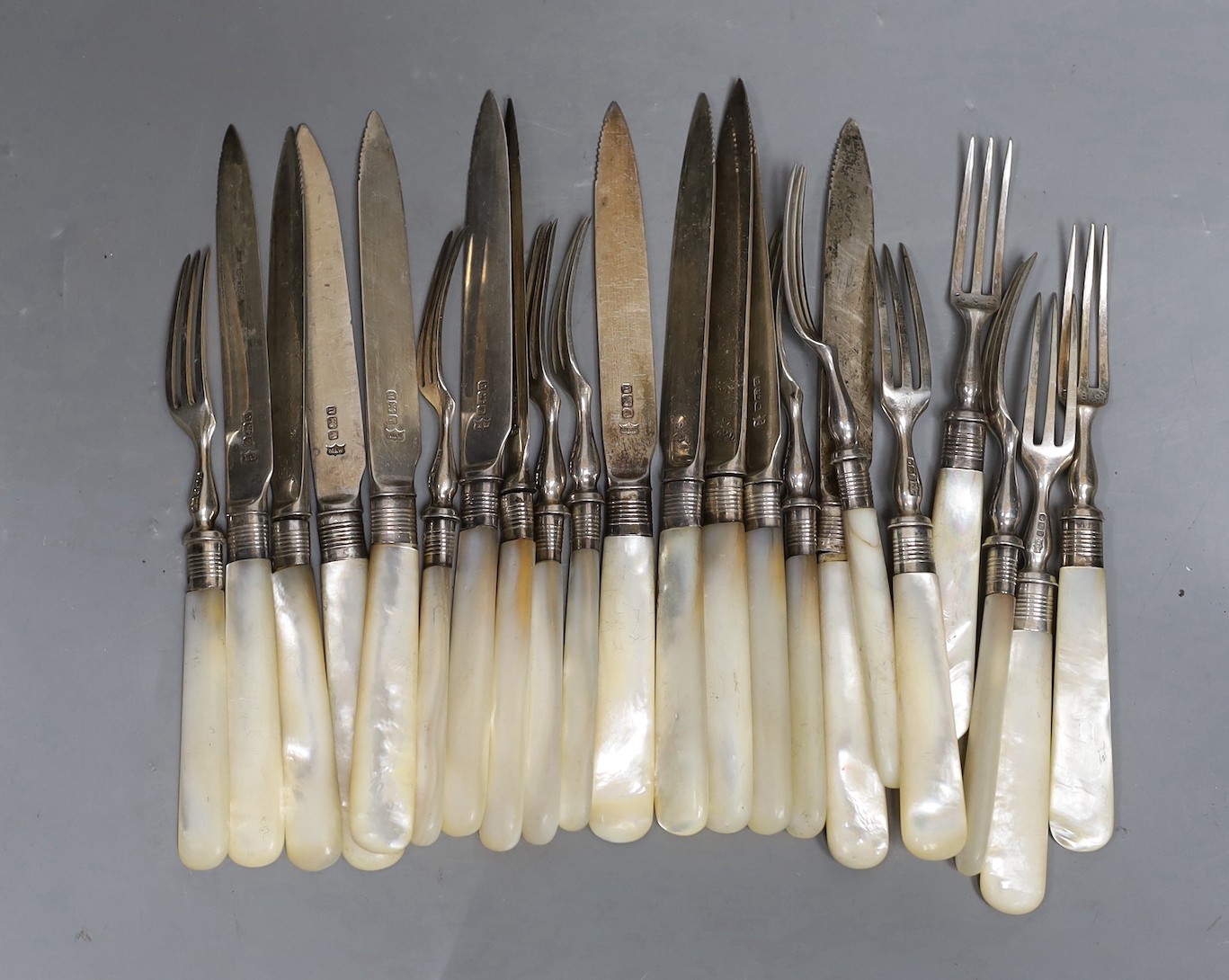 Eleven pairs of late Victorian mother of pearl handled silver dessert eaters, Mappin & Webb, Sheffield, 1894.                                                                                                               
