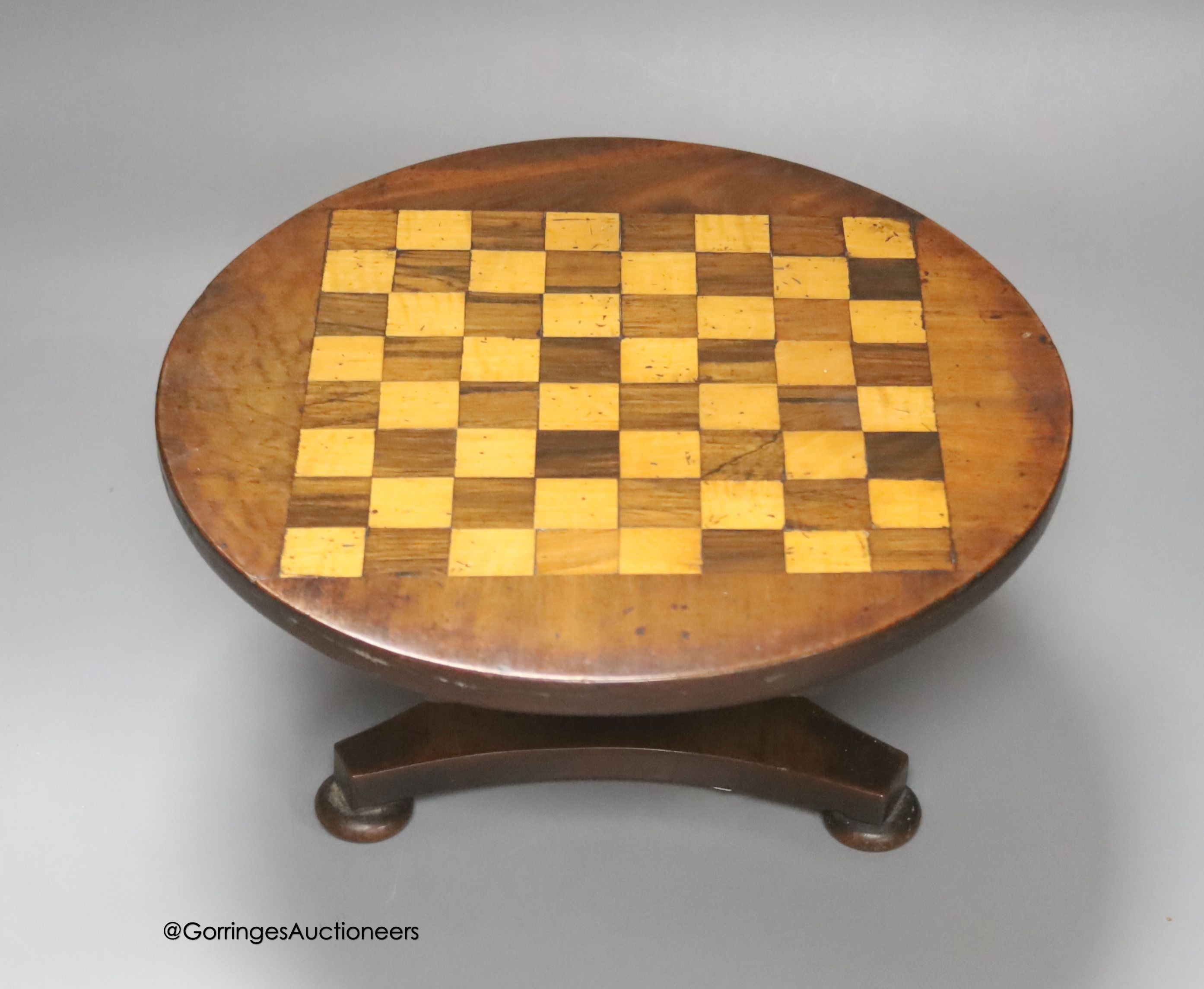 An Apprentice made miniature mahogany, rosewood and satiwnood tilt top games table, diameter 27cm                                                                                                                           