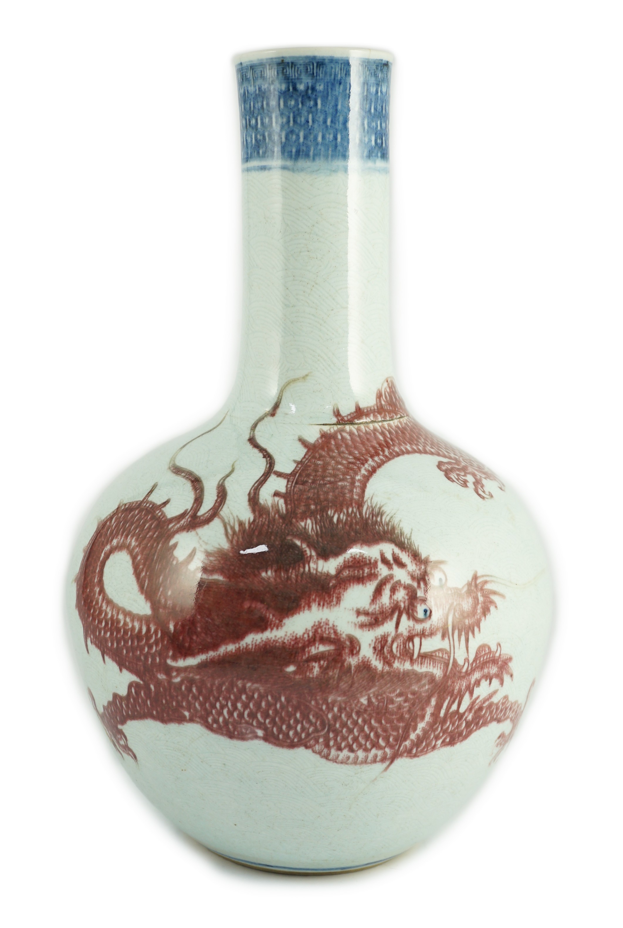 A rare Chinese underglaze blue and copper red 'dragon' vase, tianqiuping, 18th century, 38cm high, firing faults, hairline cracks                                                                                           