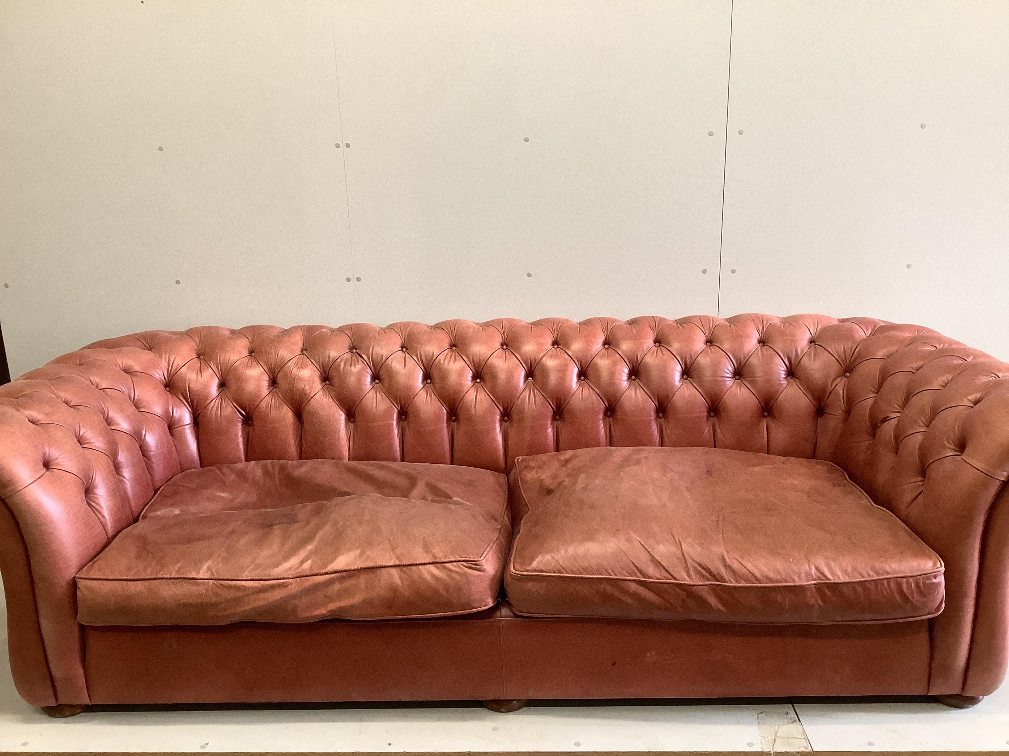 A large Victorian style buttoned back pale red leather Chesterfield settee, width 270cm, depth 104cm, height 76cm                                                                                                           