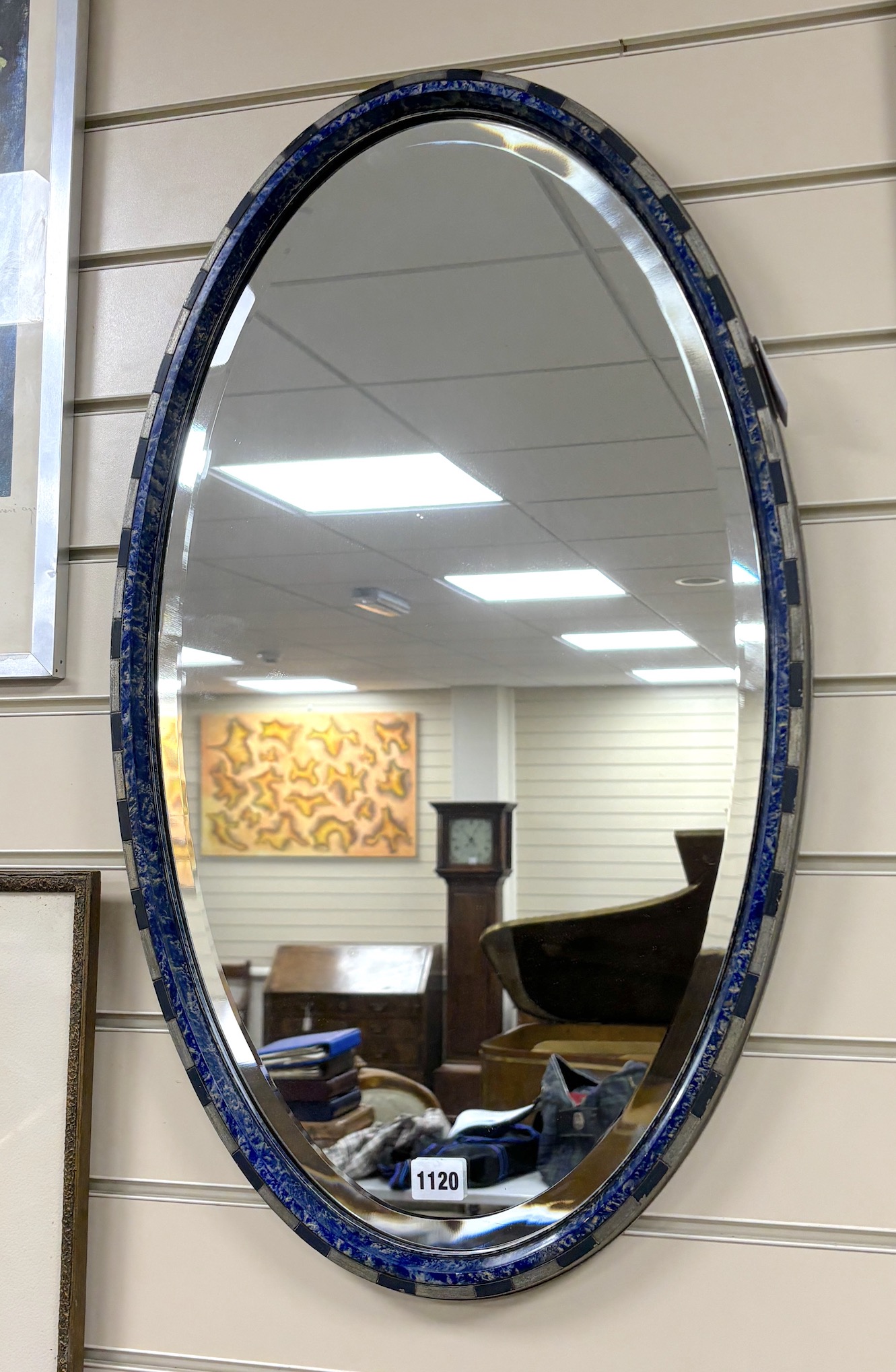 A painted oval faux malachite wall mirror, width 43cm, height 72cm                                                                                                                                                          