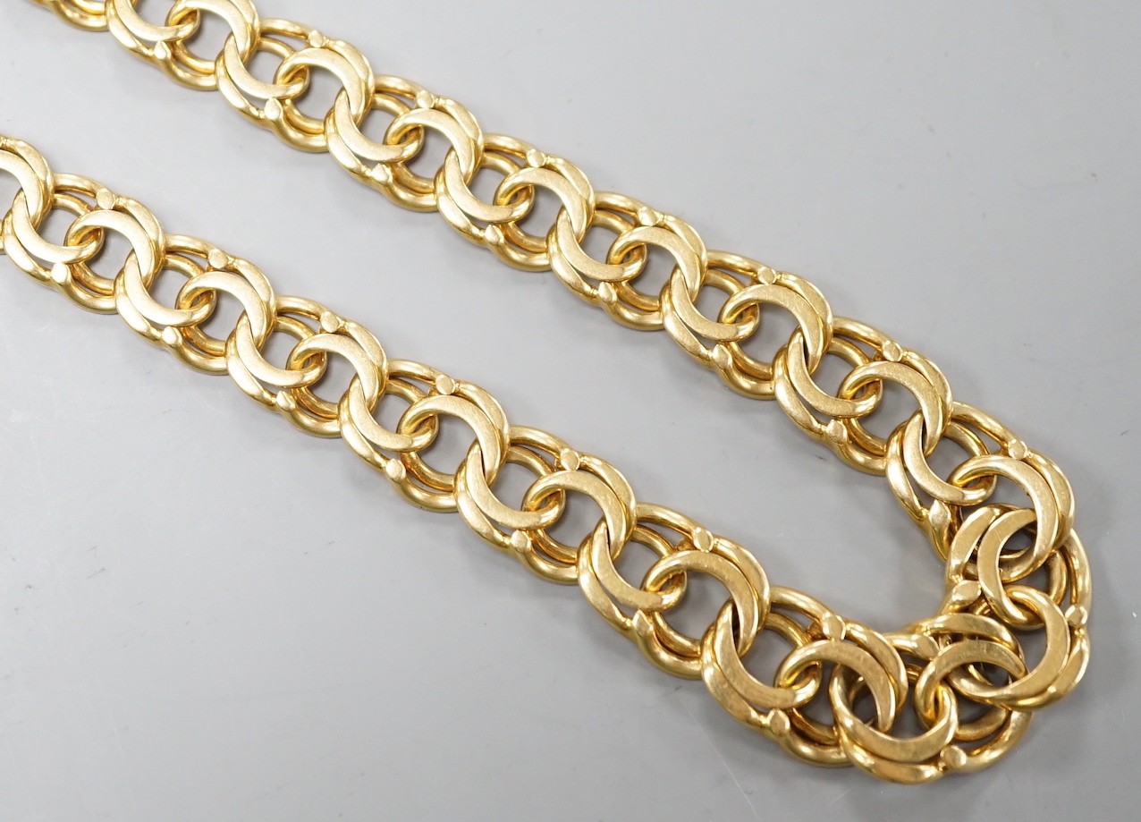 A yellow metal graduated interwoven circular link necklace, 53cm, 42.1 grams.                                                                                                                                               