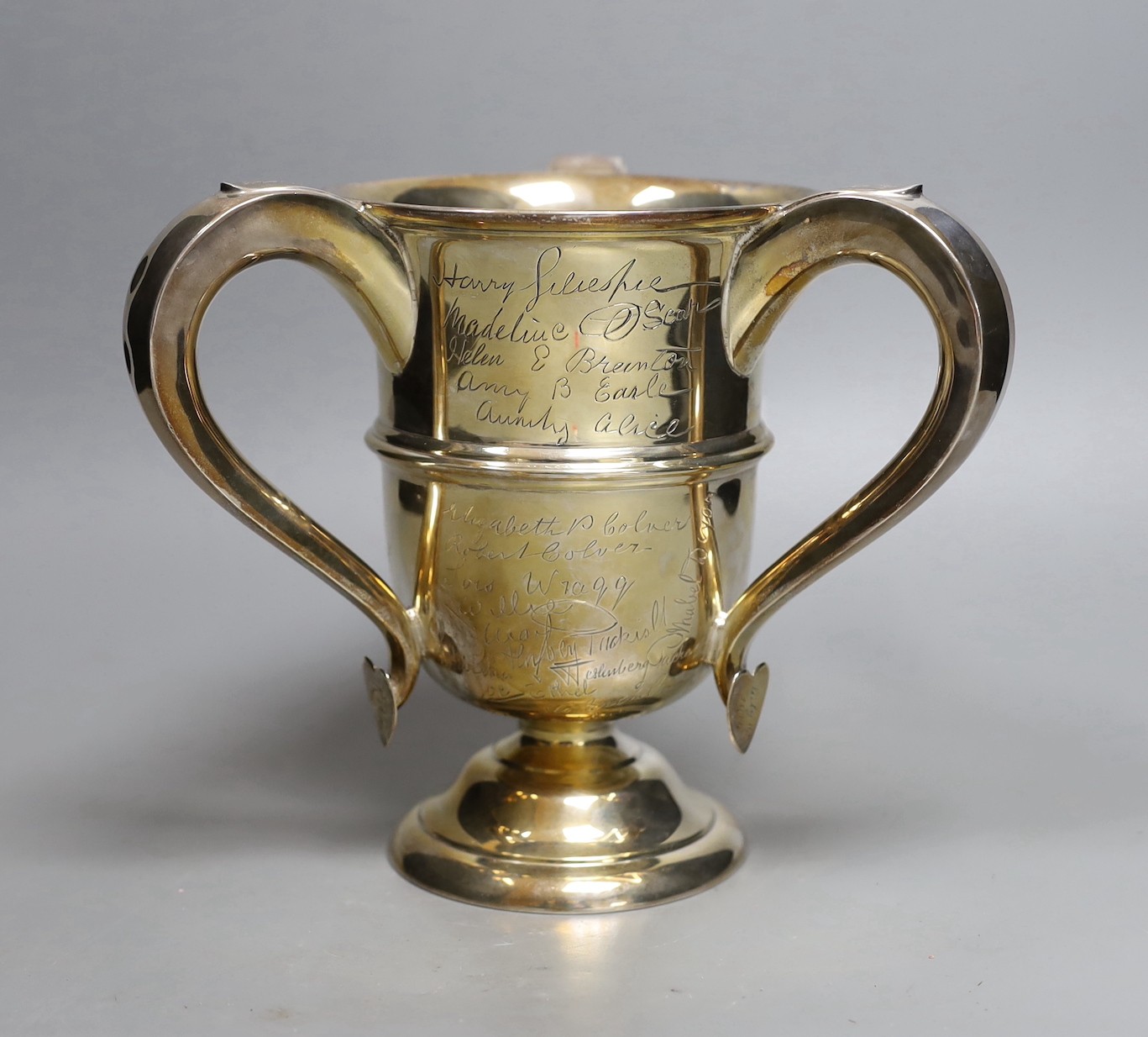 A George V silver tyg, with engraved signatures throughout, Walker & Hall, Sheffield, 1913, height 18.9cm, 23.2oz.                                                                                                          