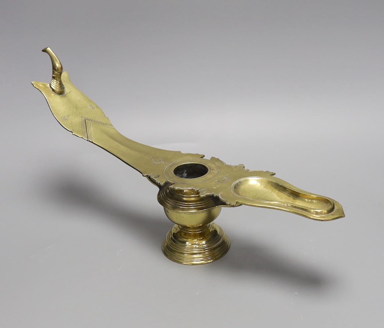 A 19th century Indian brass oil lamp, 45 cms wide                                                                                                                                                                           