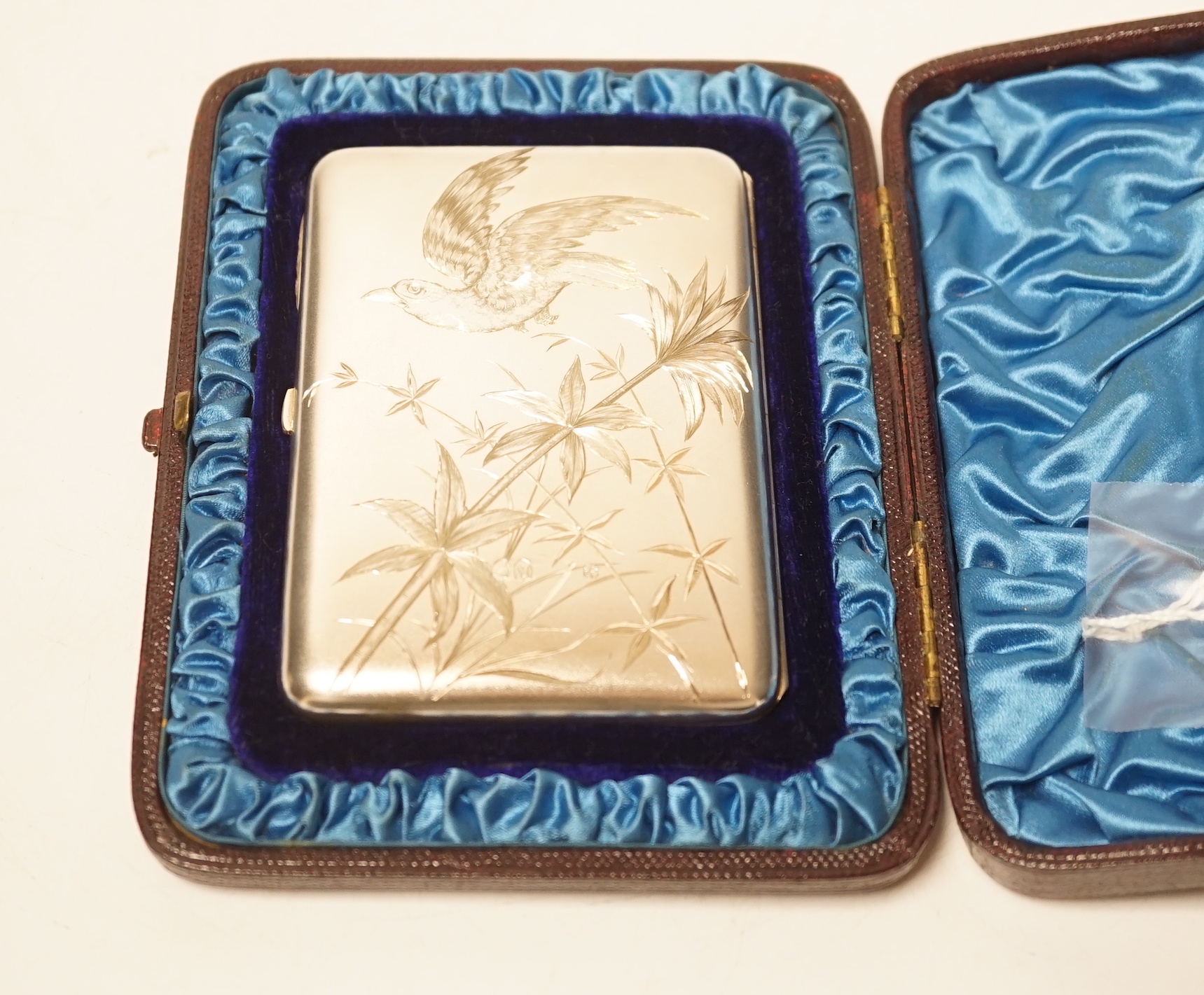 A Victorian aesthetic movement engraved silver card purse, Alfred Hall & John Goode, London, 1885, 10.1cm, in original fitted case.                                                                                         