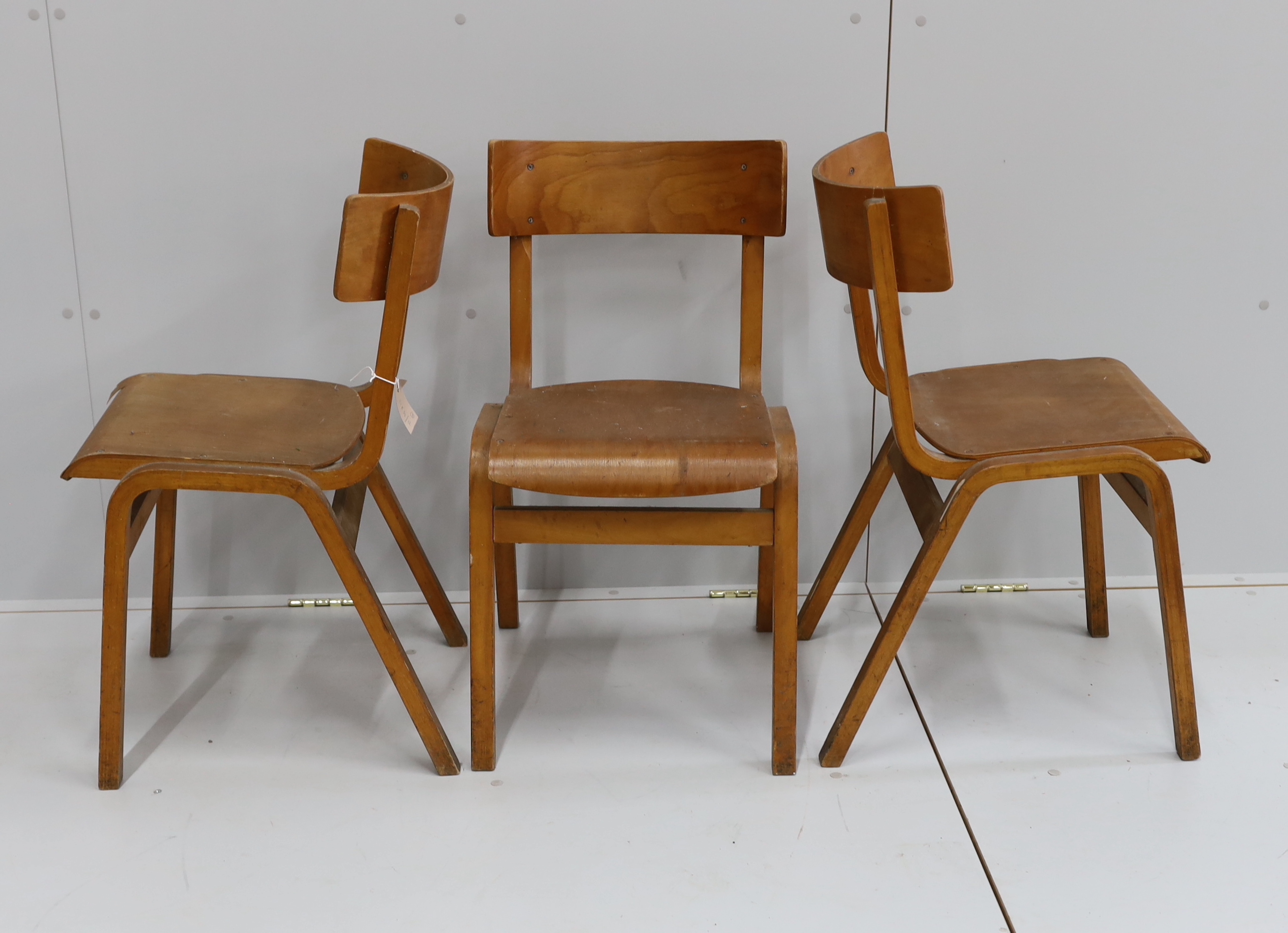 A set of three mid century bent ply chairs                                                                                                                                                                                  