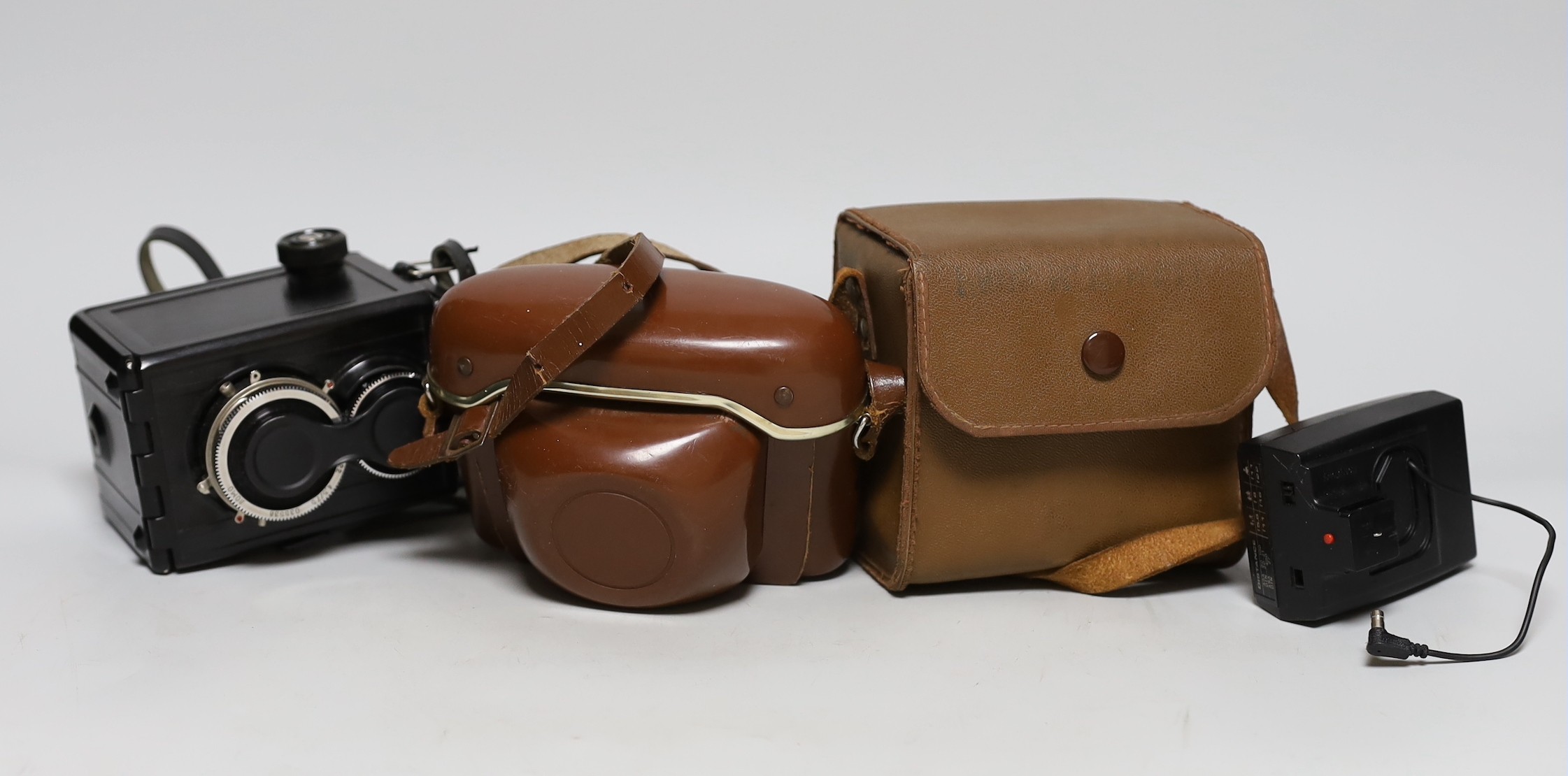 Three cameras, two cased plus a flash and light meter                                                                                                                                                                       