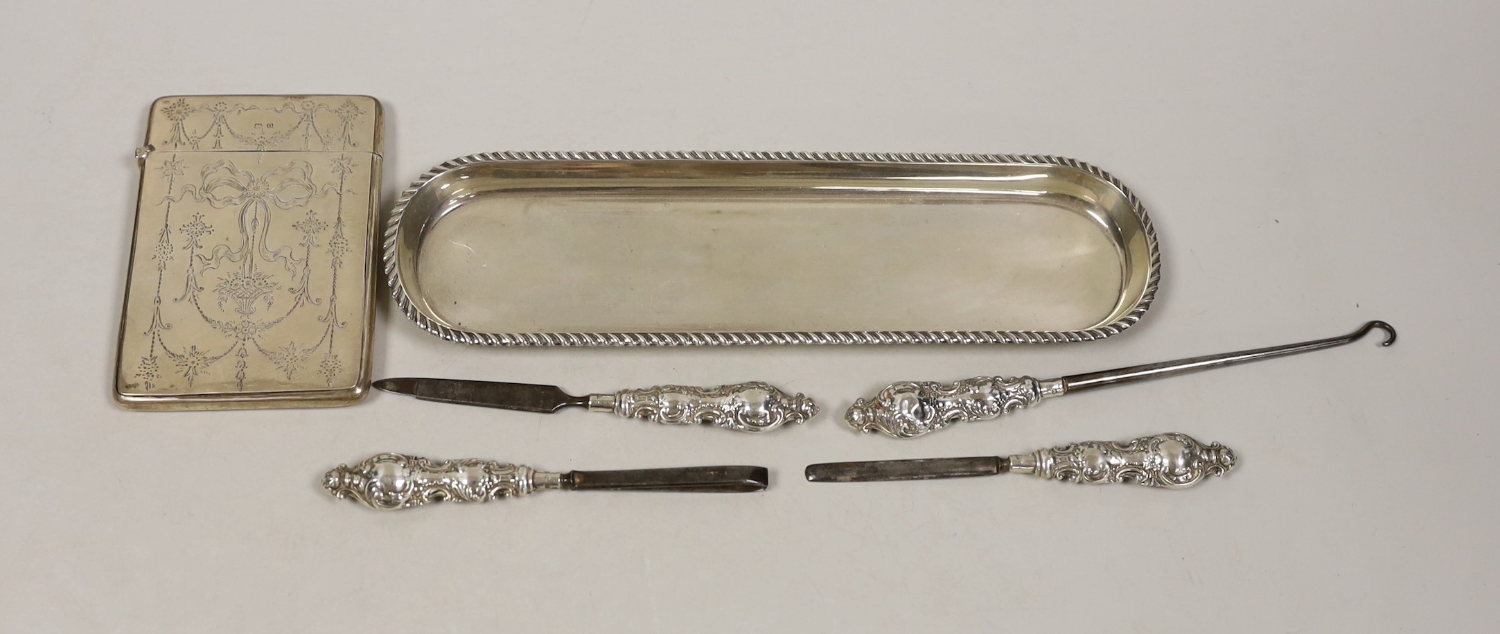A George V engraved silver card case, by Crisford & Norris, a silver pen tray and four manicure tools.                                                                                                                      