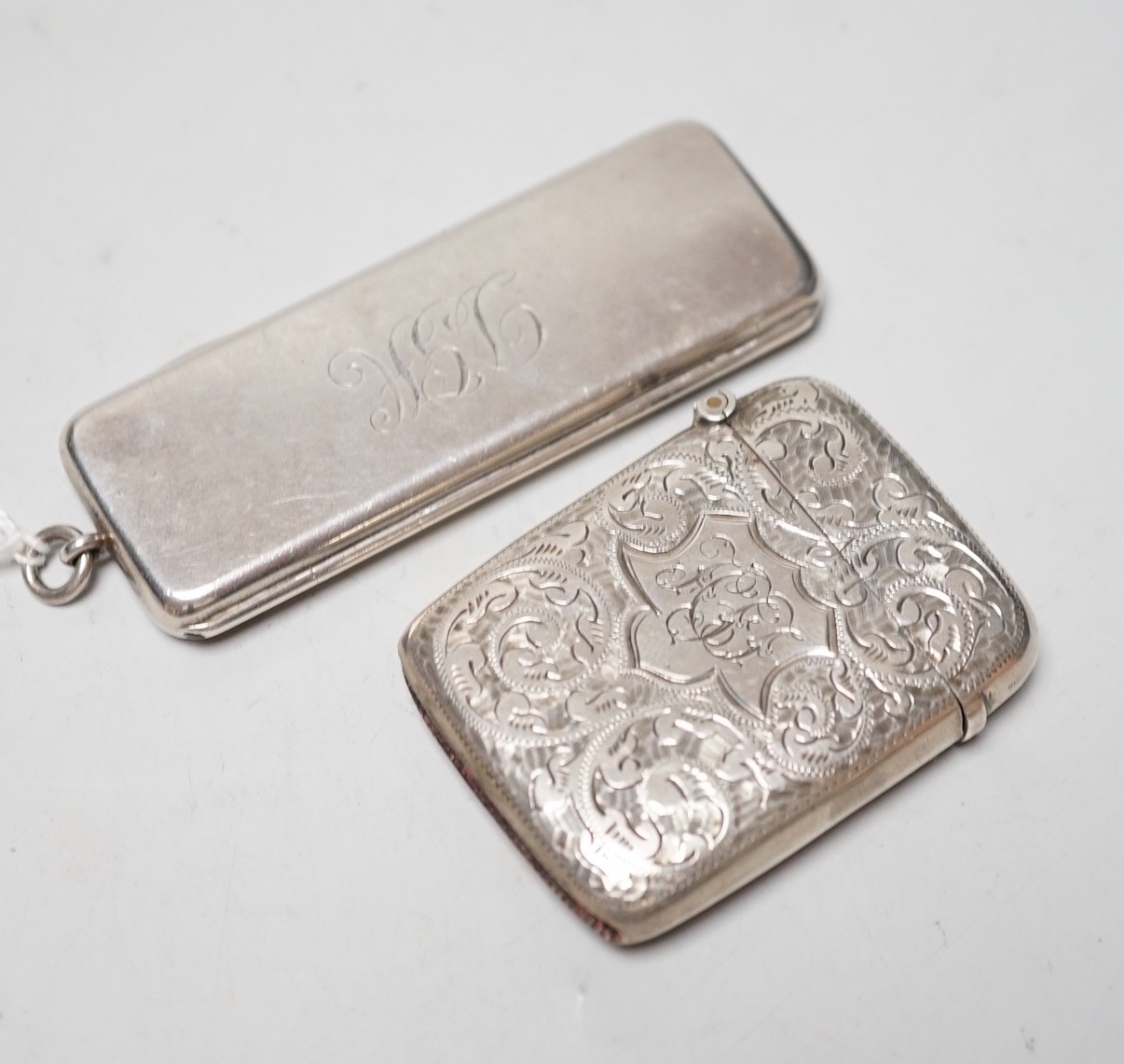 An Edwardian silver rectangular cigarette paper dispenser, maker WH, no assay office mark, circa 1908, 77mm and a silver vesta case.                                                                                        