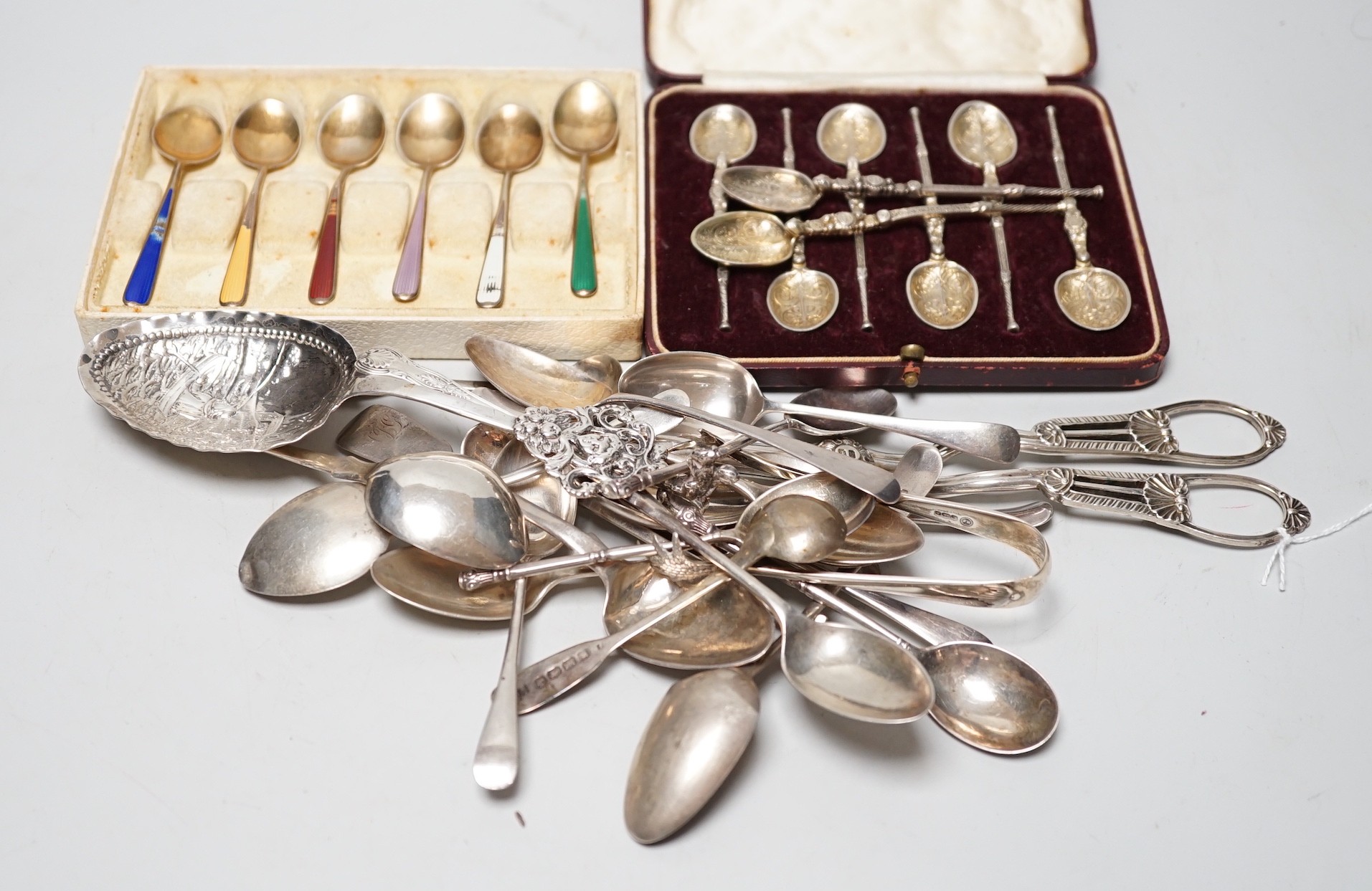 A pair of George V silver grape shears, George Howson, Sheffield, 1912, together with a small quantity of silver and white metal flatware including a set of six continental 925 and enamel coffee spoons.                  