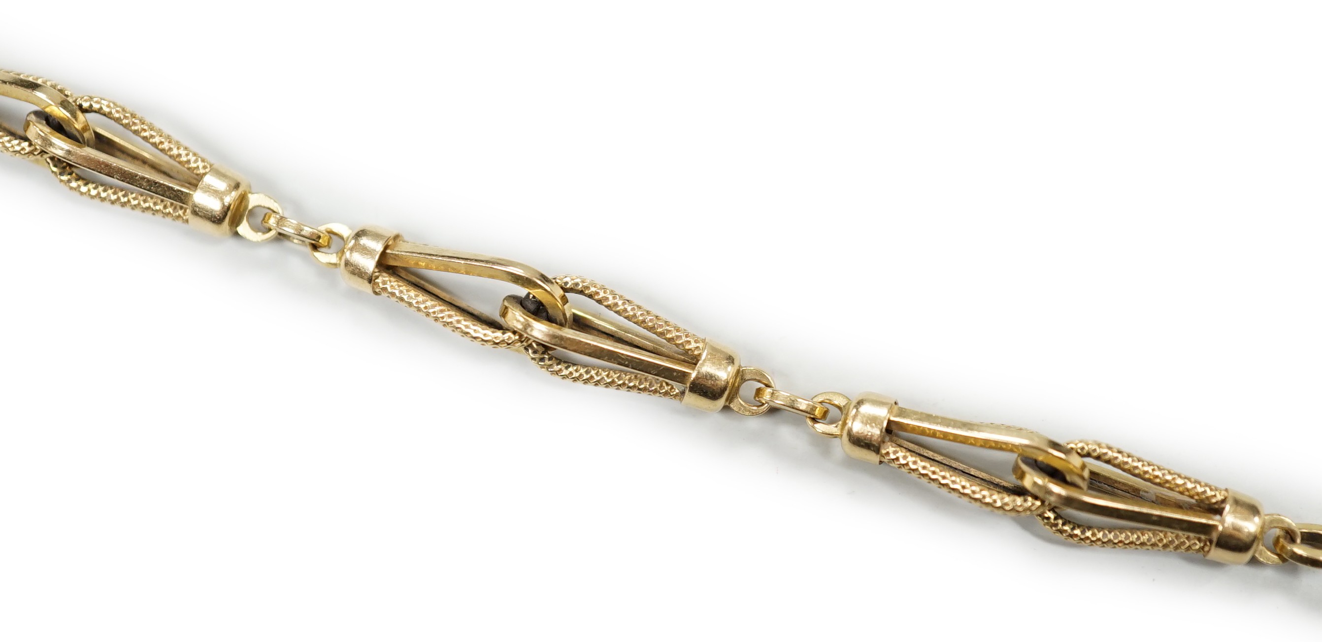 An 18k yellow metal fancy link bracelet with 14k clasp, 21cm, 10.7 grams.                                                                                                                                                   