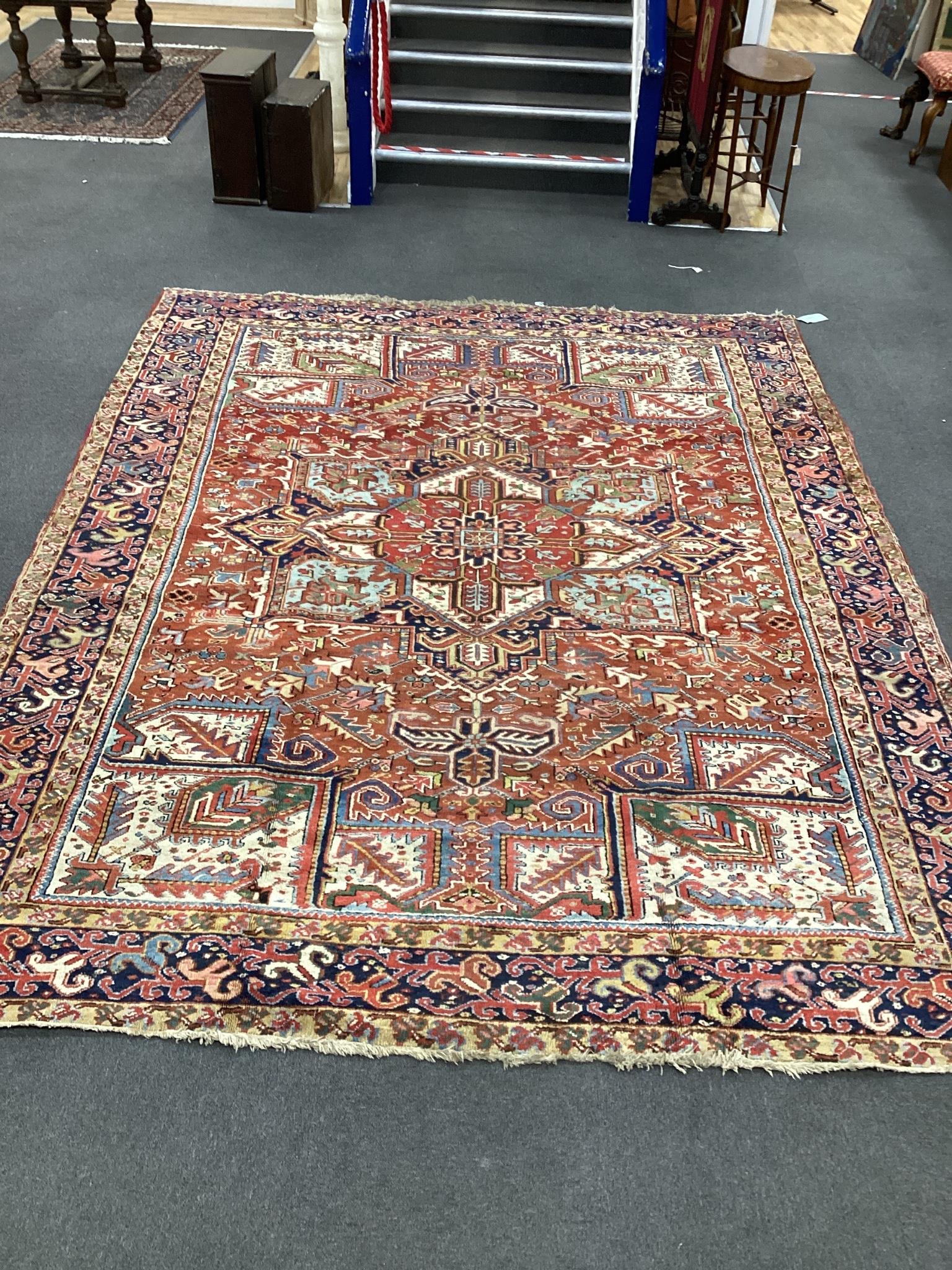 An early 20th century Heriz red ground carpet, 336 x 250cm                                                                                                                                                                  