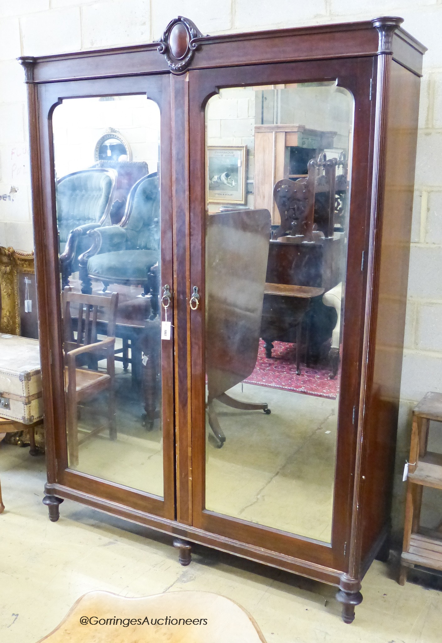 An early 20th century continental mirrored mahogany wardrobe. W-160, D-55, H-219cm.                                                                                                                                         