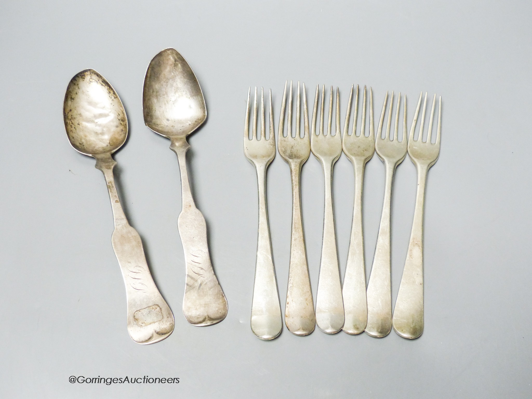 A set of six George III Irish silver Hanovarian pattern dessert forks, John Pittar, Dublin, 1788, 19.2cm and two other continental white meta spoons, gross 14.5oz.                                                         
