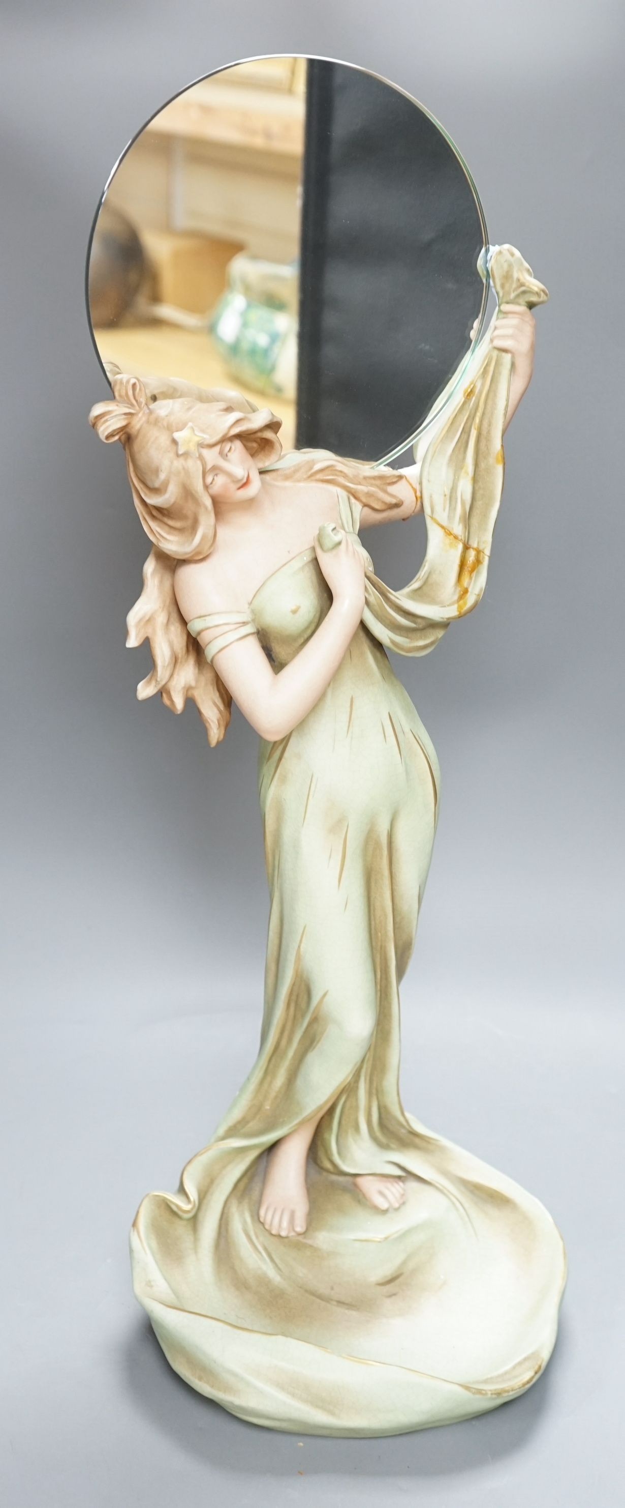 A continental Art Nouveau ceramic figure of a lady holding a mirror, 57cms high not including mirror                                                                                                                        
