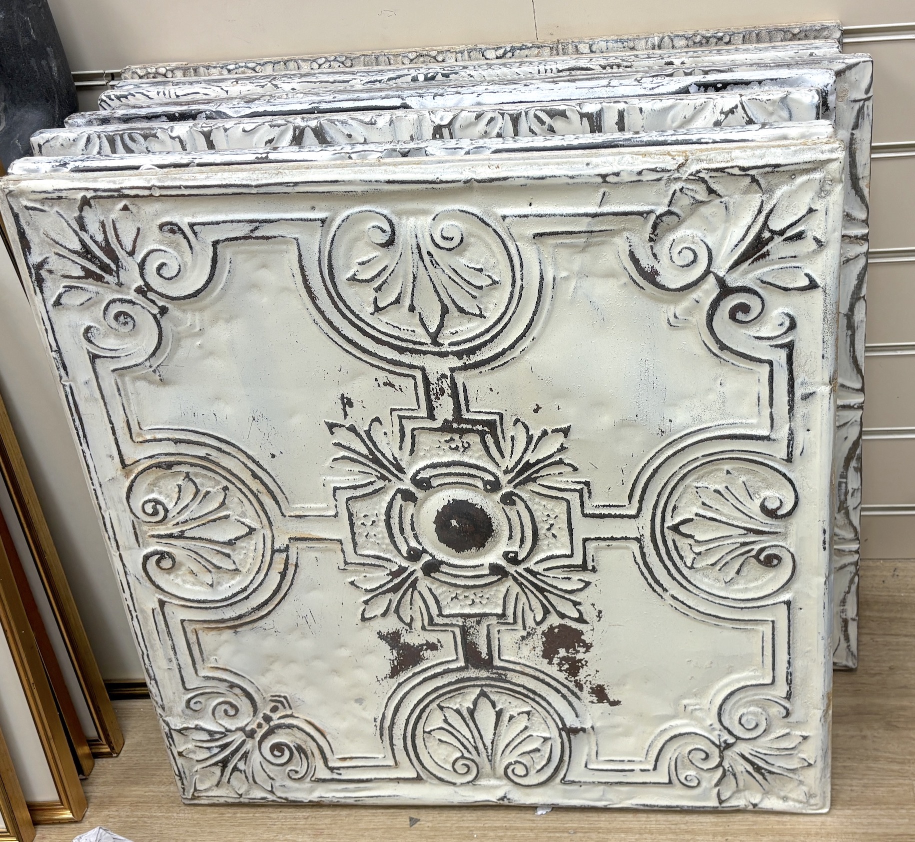 A group of nine decorative pressed tin panels made from salvaged antique tin ceilings, 59cm sq.                                                                                                                             