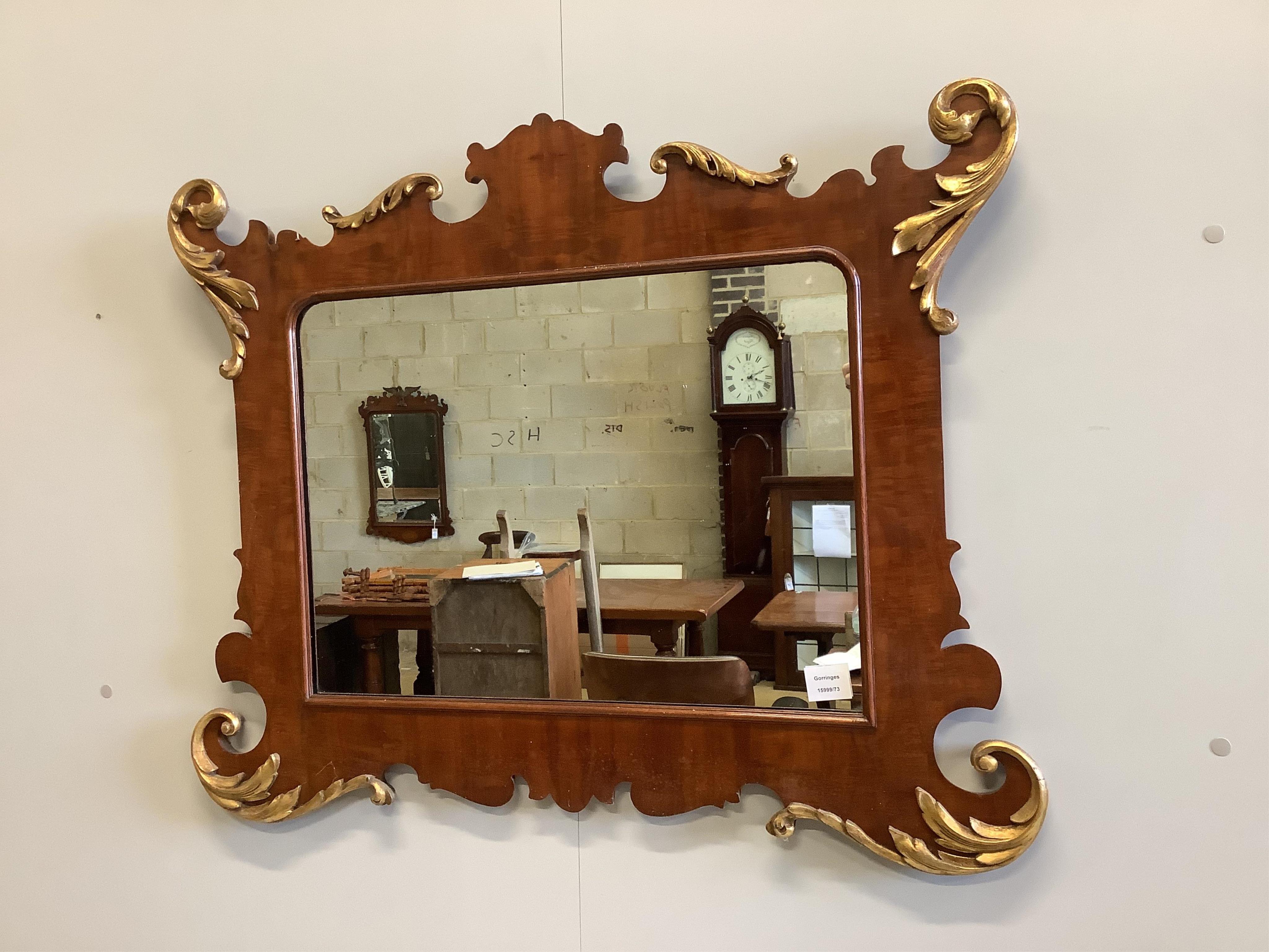 A George II style parcel gilt mahogany fret cut wall mirror, width 89cm, height 70cm. Condition - fair to good                                                                                                              