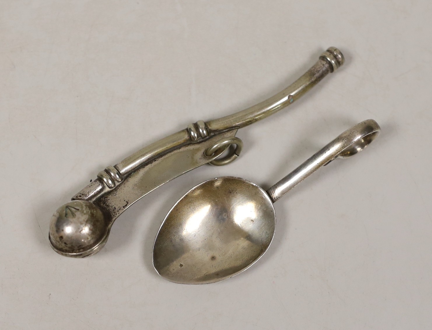 A George V silver caddy spoon and a plated bosun’s whistle.                                                                                                                                                                 