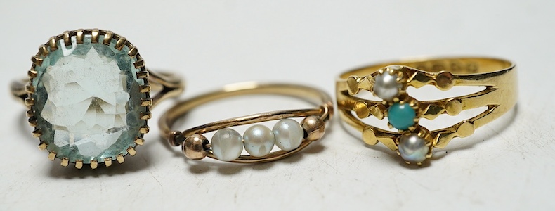 An Edwardian 18ct gold three stone pearl and turquoise set ring, size N, 2.9 grams, an unmarked triple pearl ring, size N, 1.1 grams, and an unmarked oval aquamarine ring, size O, 4.1 grams. Condition - triple pearl ring