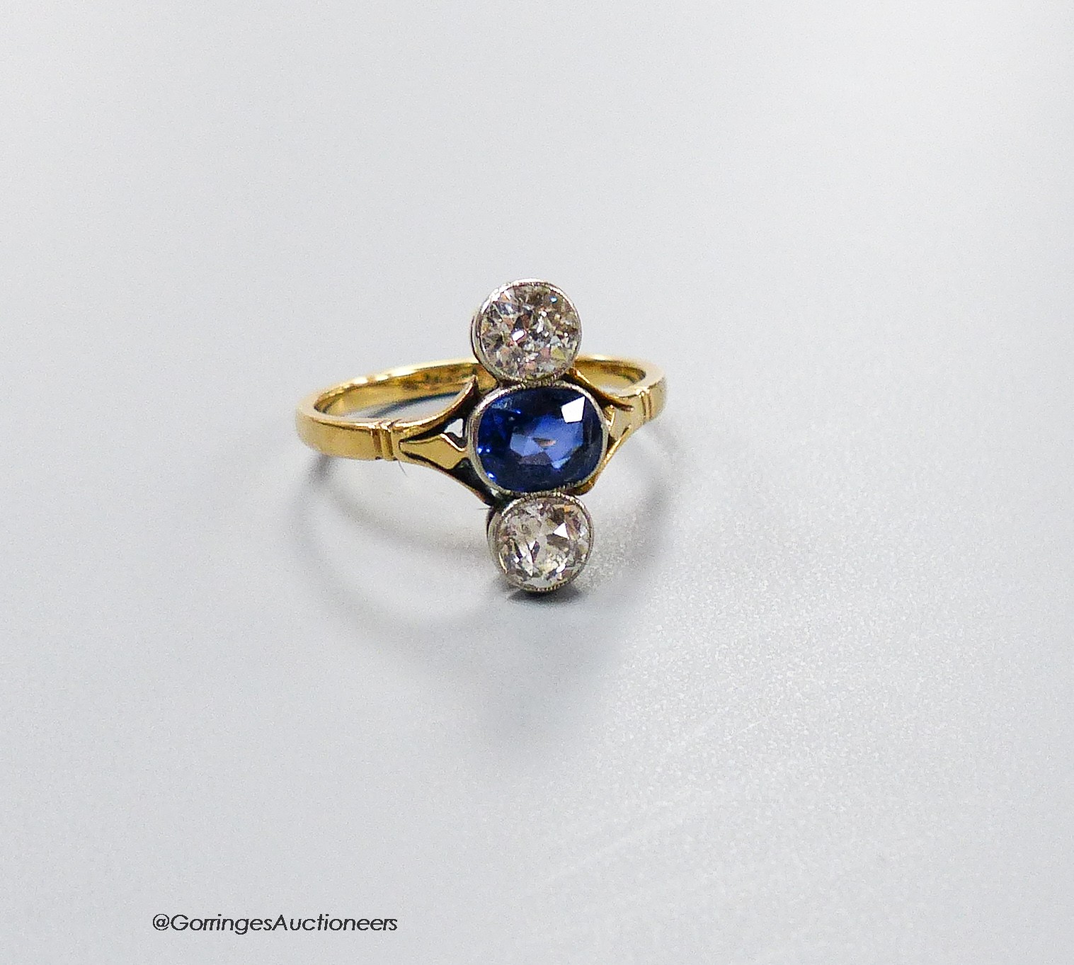 A, 18ct, two stone diamond and single stone sapphire set upfinger ring, size M, gross 2.9 grams                                                                                                                             