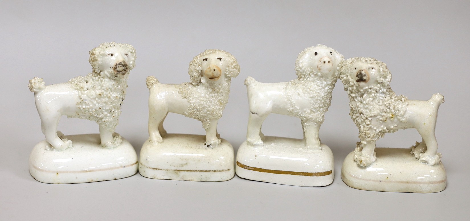Four Staffordshire models of poodles, c.1830-50, tallest 6.5cm, Provenance: Dennis G. Rice collection                                                                                                                       