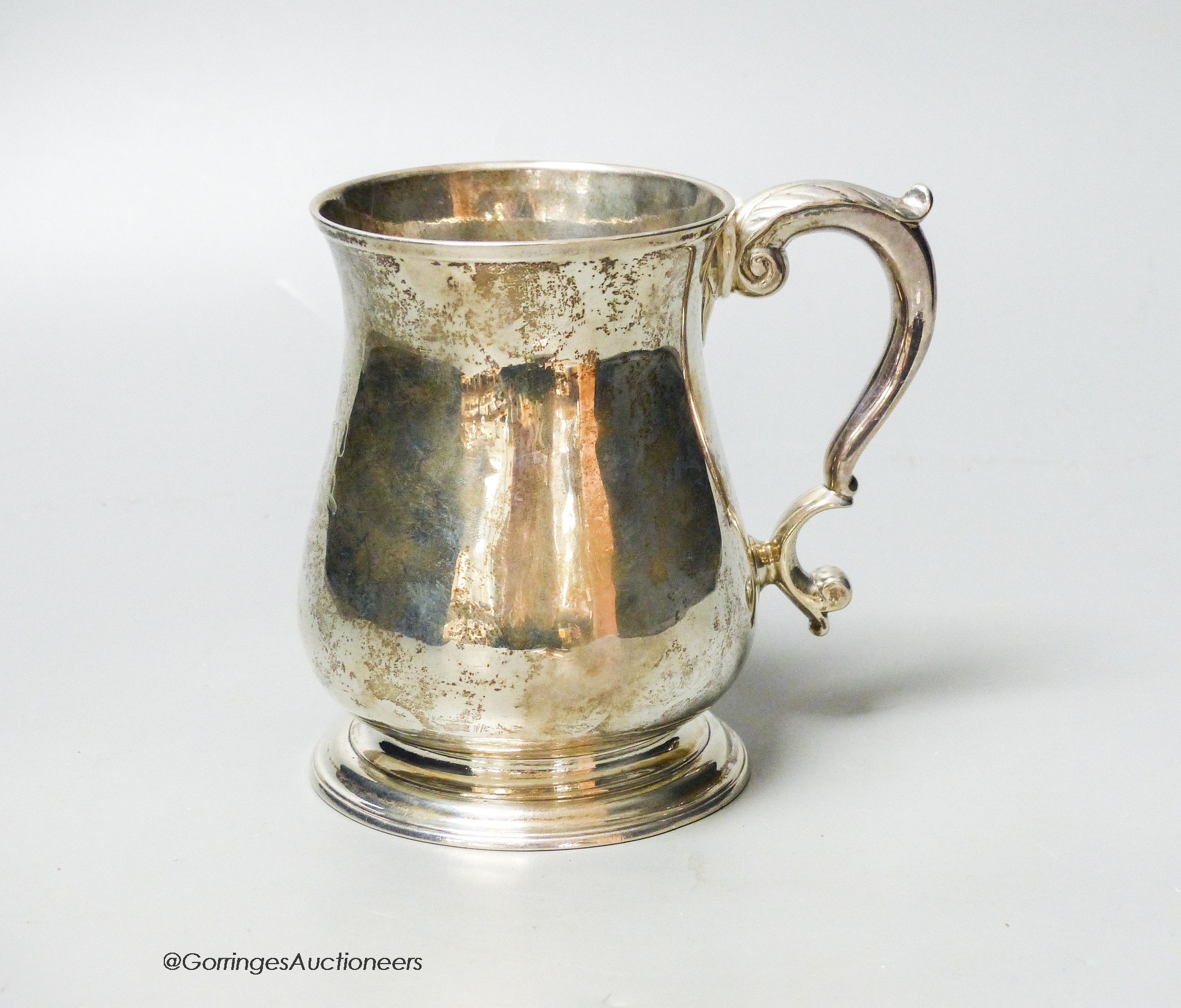 A George II silver baluster mug, with acanthus leaf capped handled and engraved crest, Henry Brind, London, 1743, height 11.7cm, 11.5oz.                                                                                    