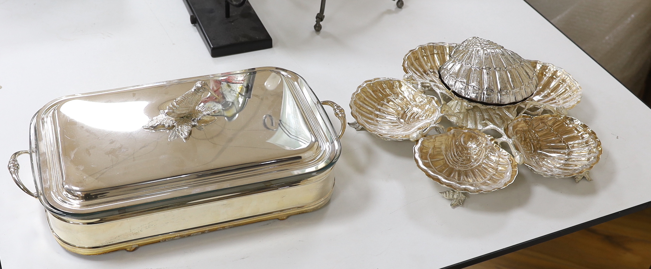 An oyster centrepiece and plated tureen and cover with glass liner, the largest 45cm wide                                                                                                                                   