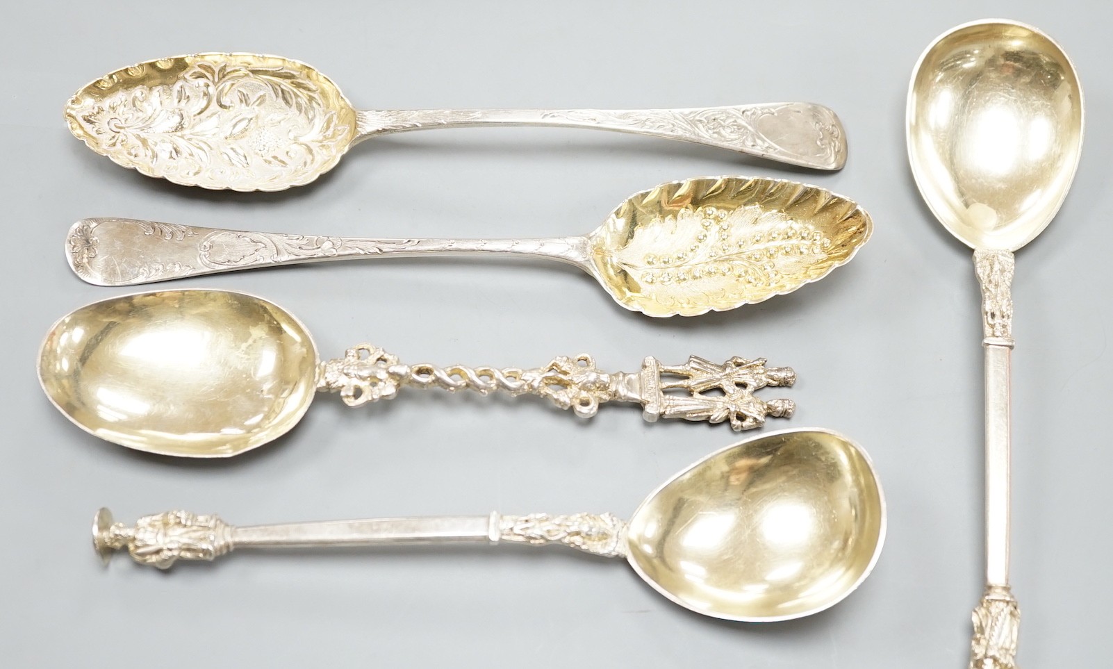 Two George III silver 'berry spoons', a pair of Victorian silver apostle serving spoons, Josiah Williams & Co, London, 1888, 19.8cm and a continental white metal spoon.                                                    