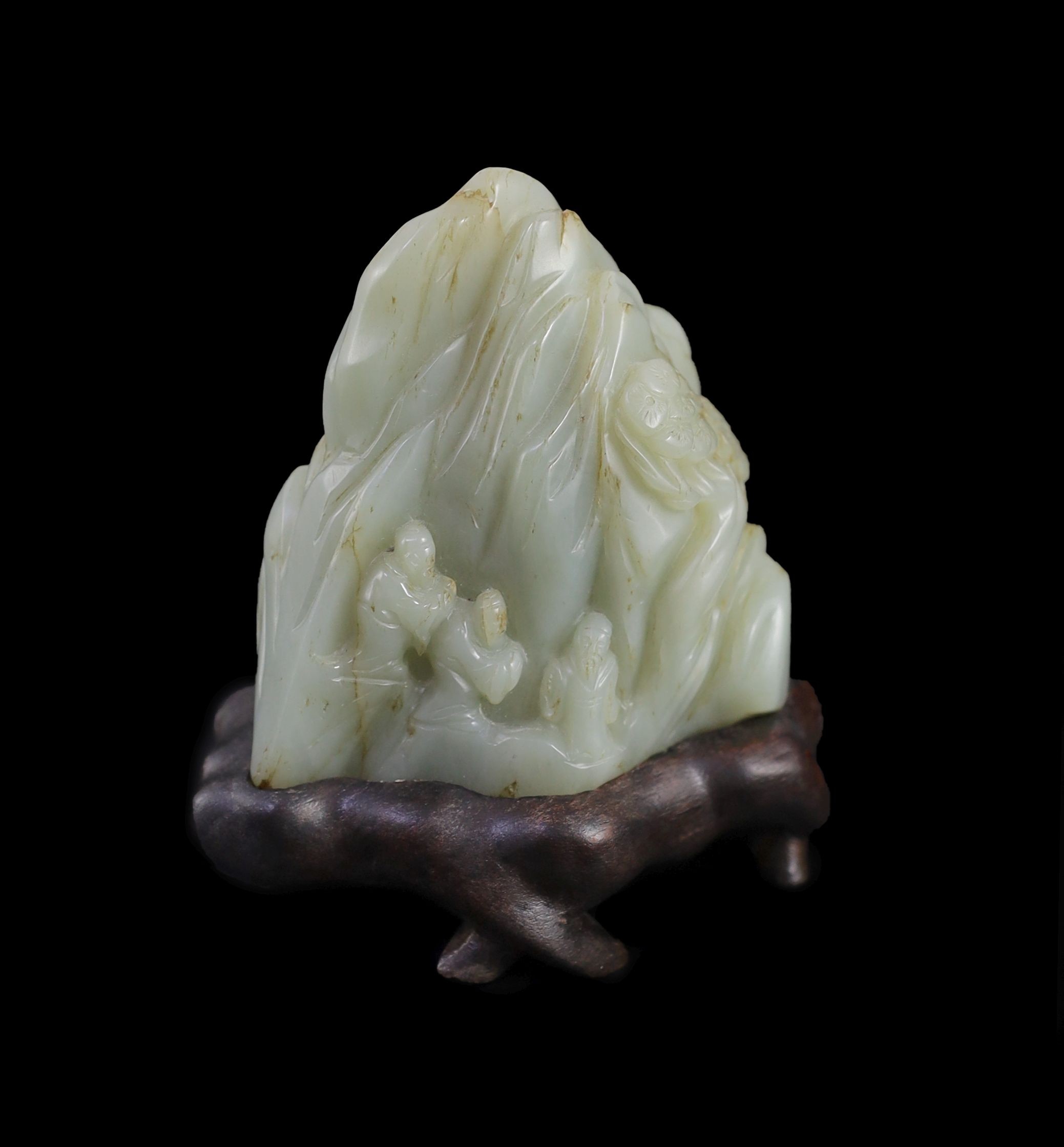 A Chinese pale celadon jade ‘Sanqing’ boulder carving, 18th century, 9.5cm high, 12 with wood stand                                                                                                                         