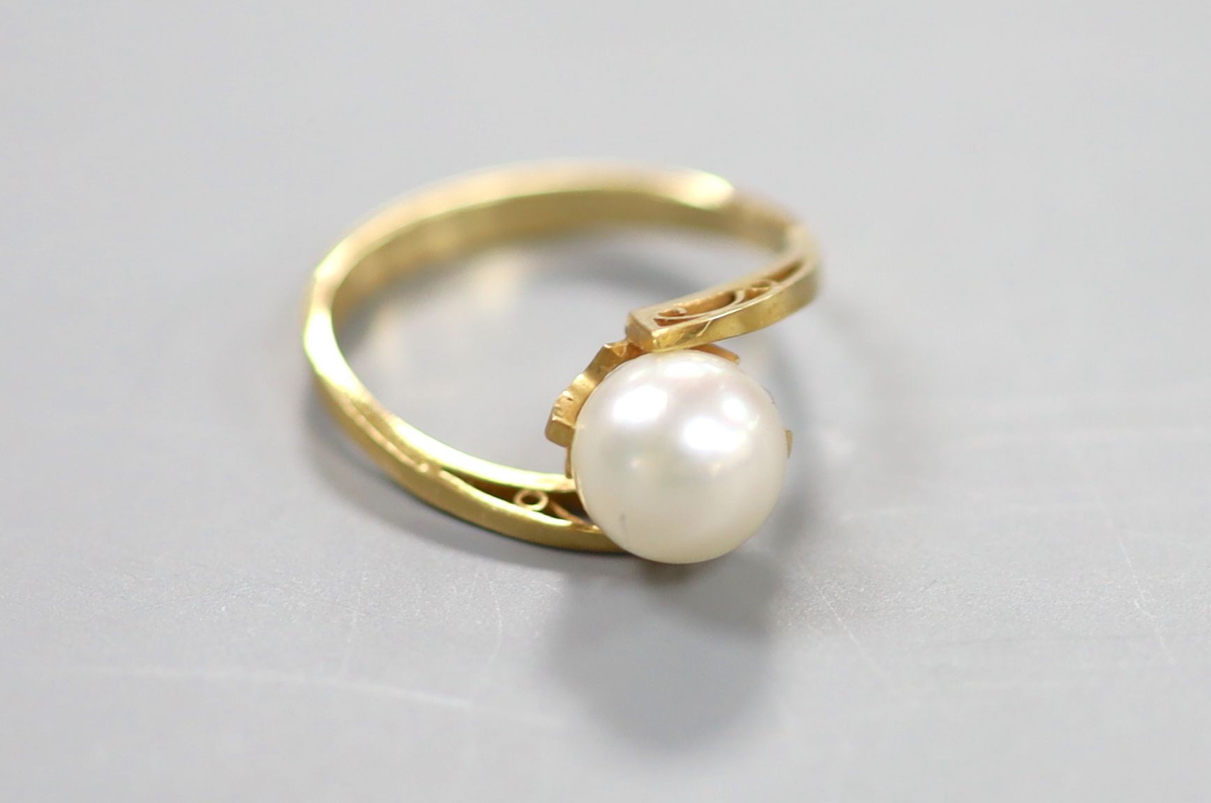 A modern 18k and cultured pearl set ring, size L, gross 2.4 grams.                                                                                                                                                          