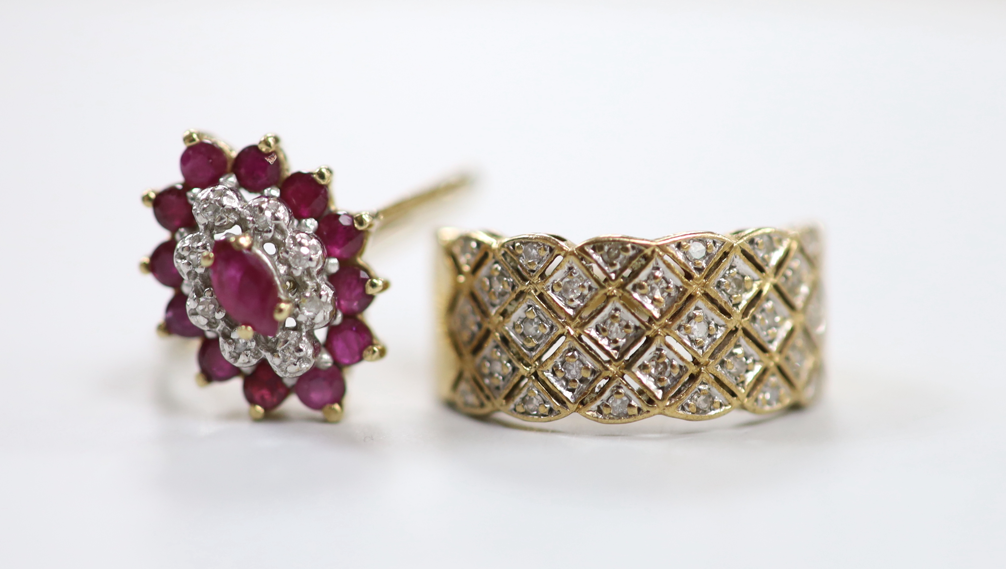 A modern 9ct gold, ruby an diamond chip set marquise cluster dress ring, size M and a similar 9ct gold and diamond chip ring, gross weight 5.5 grams.                                                                       